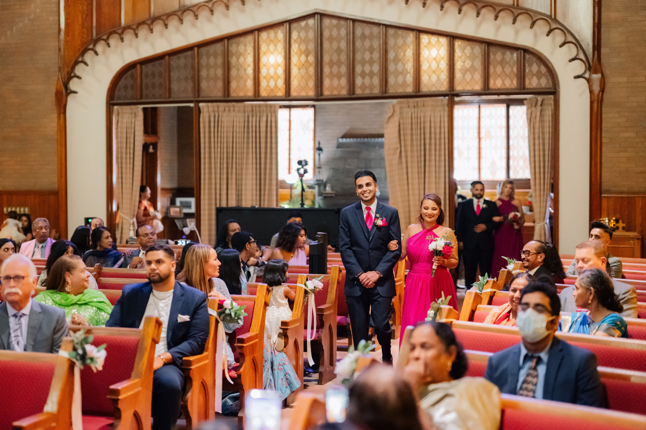 a man in a suit and tie standing in a church