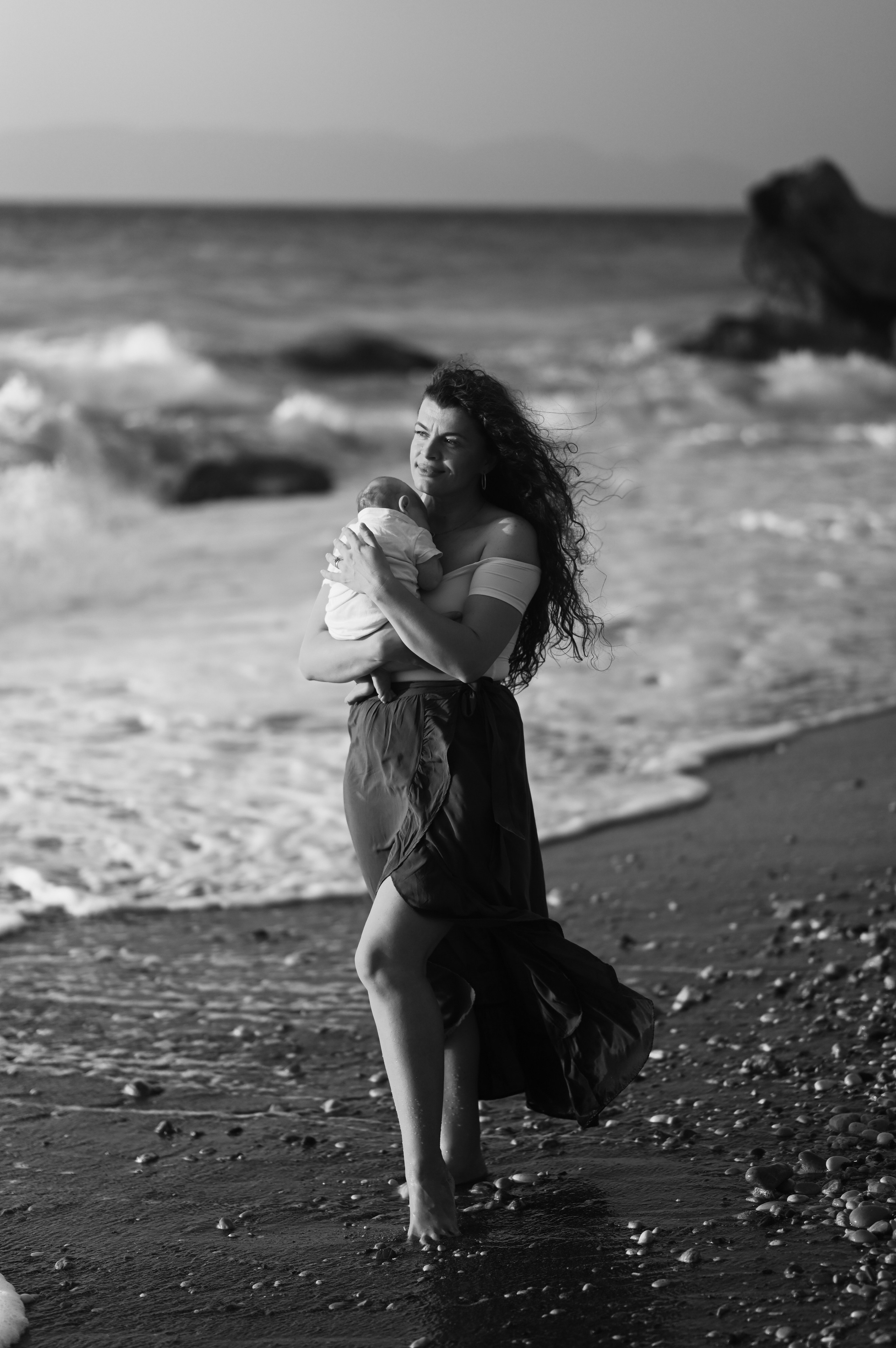 Happy family walking along a Rhodes beach at sunset. Photographer in Rhodes Island