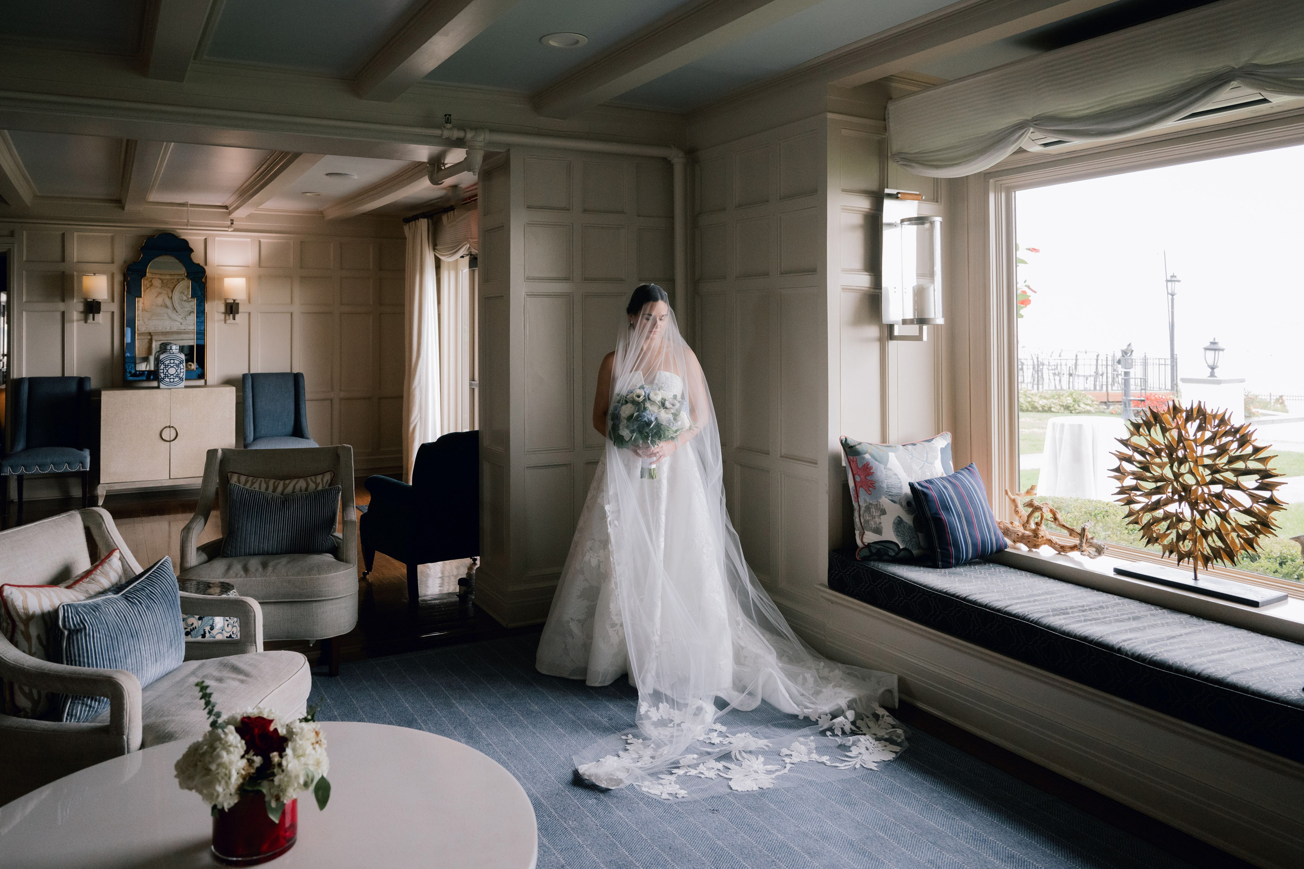 a bride standing in a room with a window