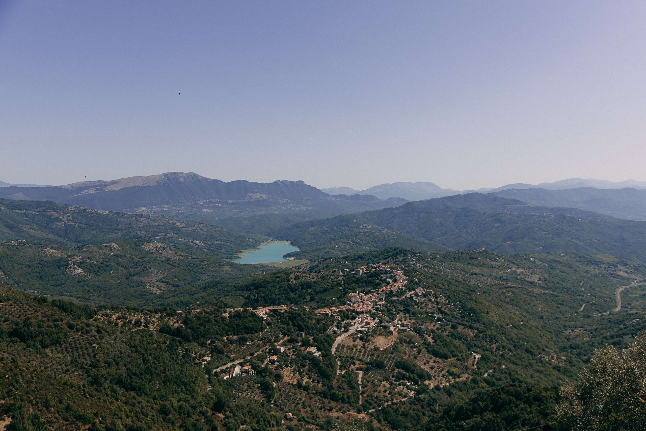 Panoramic view of mountains and a lake from the castle terrace in Cilento, Italy