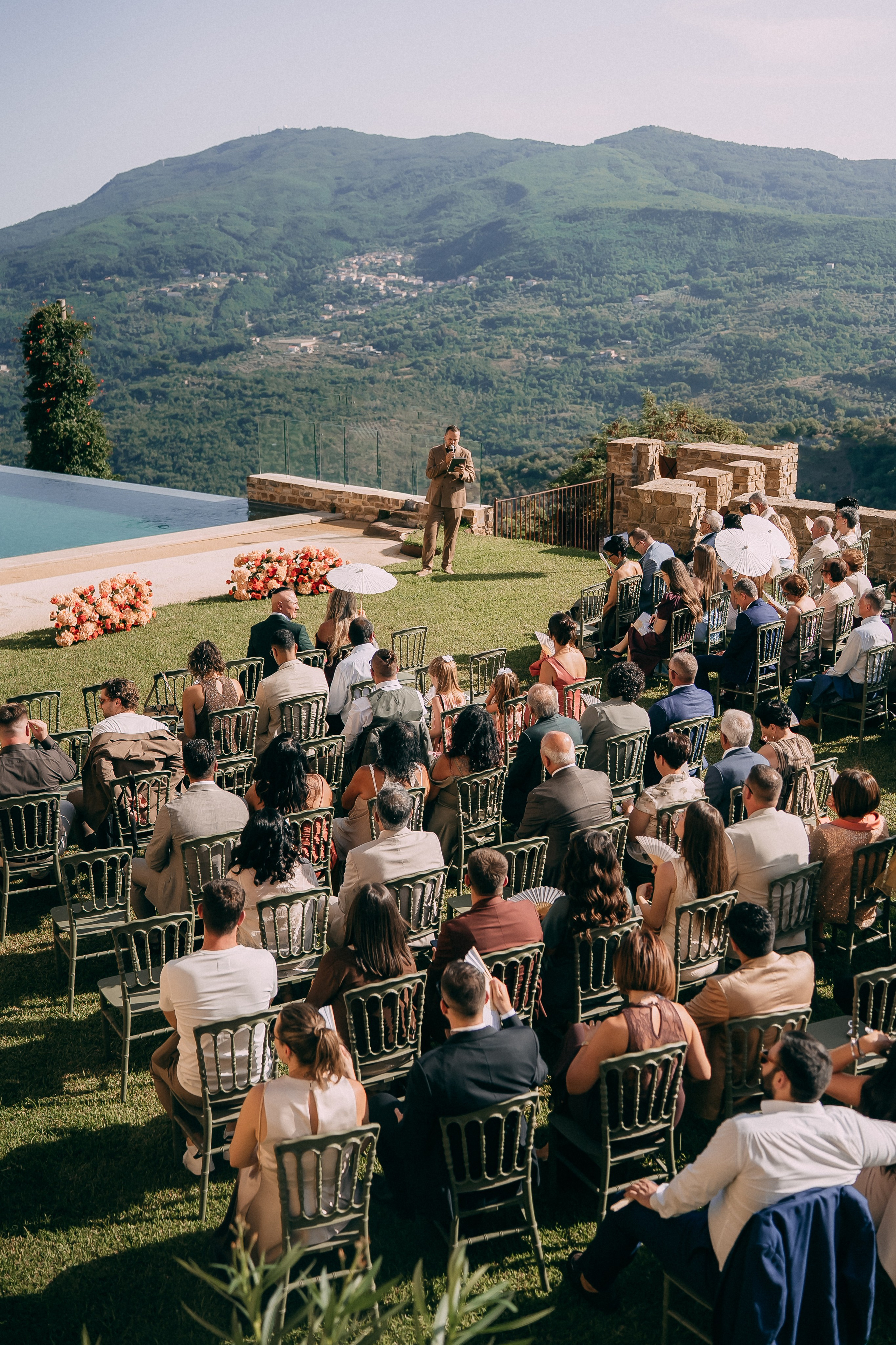 Wedding ceremony by the infinity pool overlooking the Italian hills