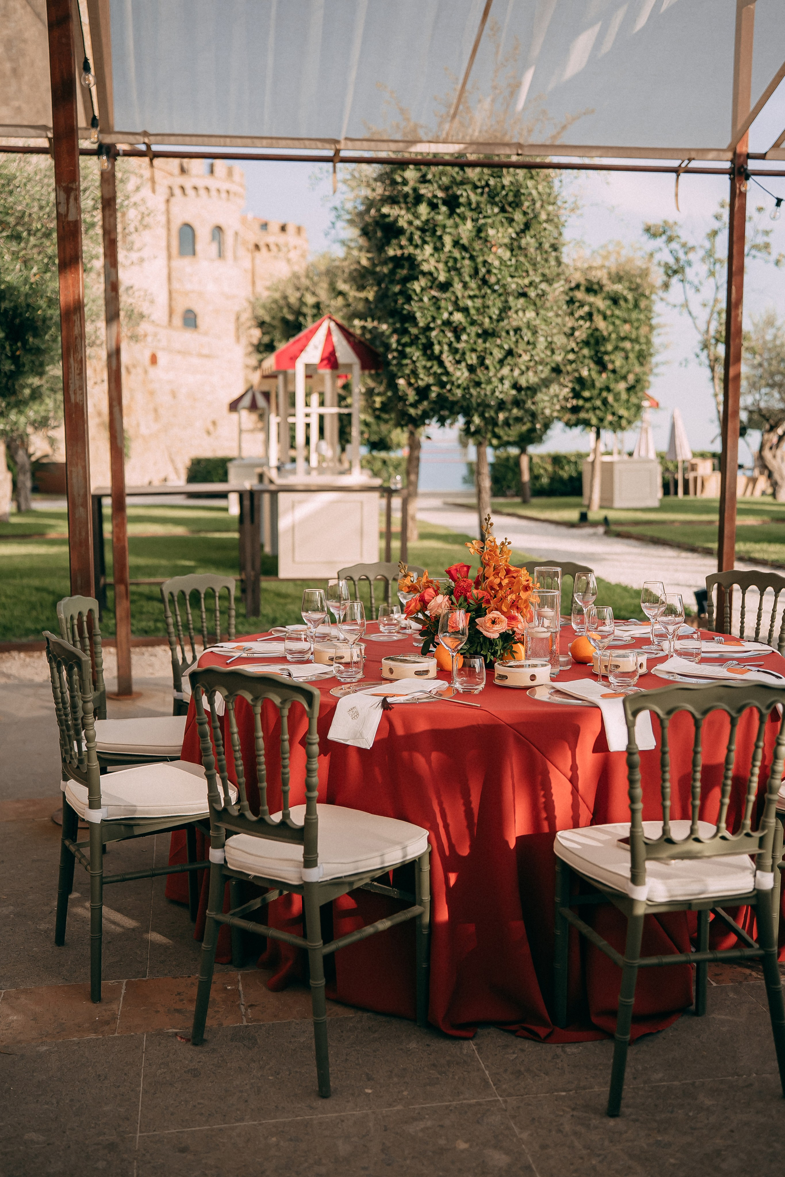 Reception tables under a marquee with the castle in the background