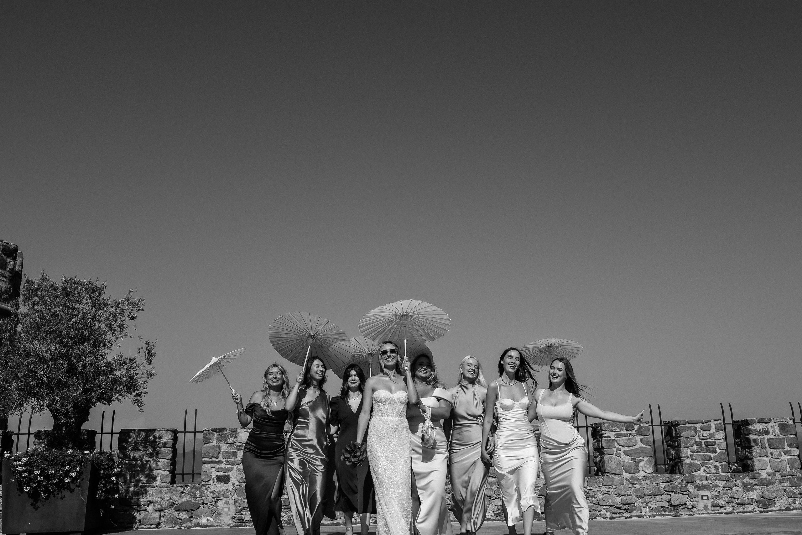 Black and white photo of the bride and her bridesmaids laughing together