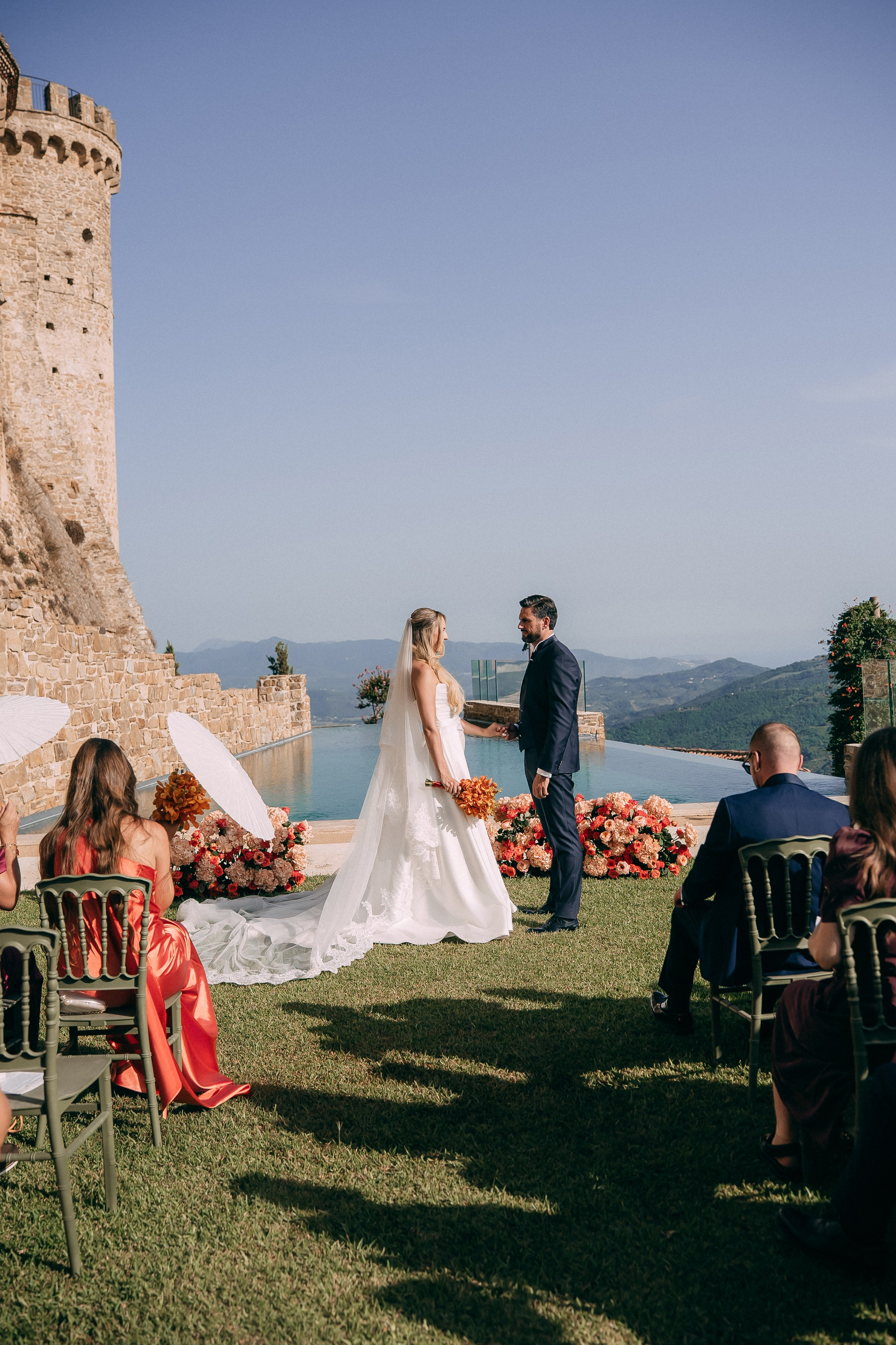 Bride and groom at the ceremony altar above the infinity pool