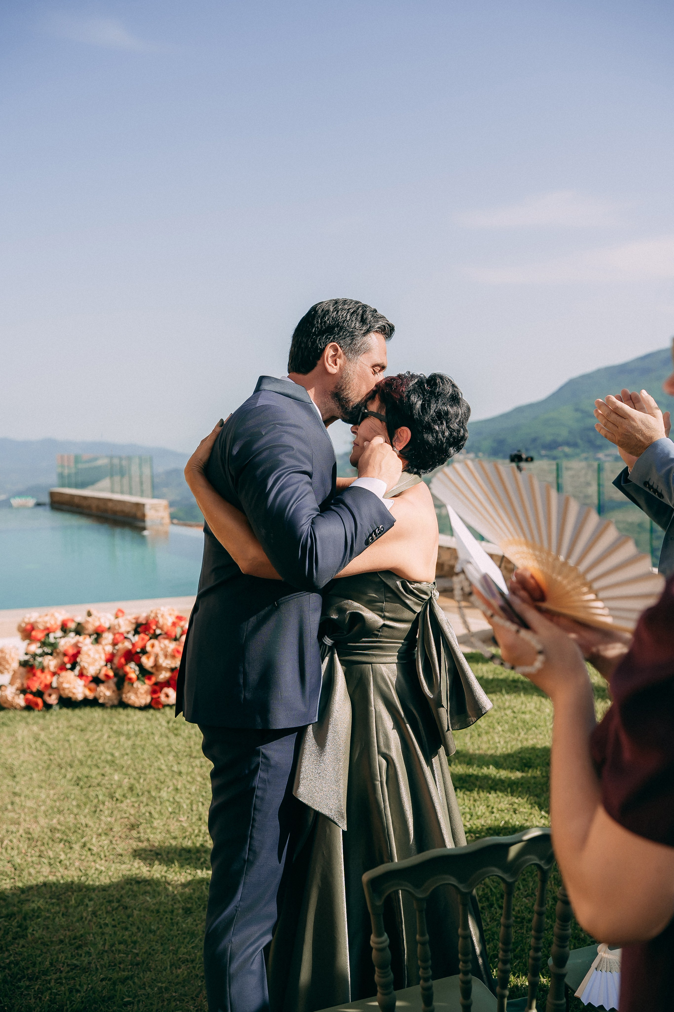 Emotional guests embracing during the wedding ceremony in Italy