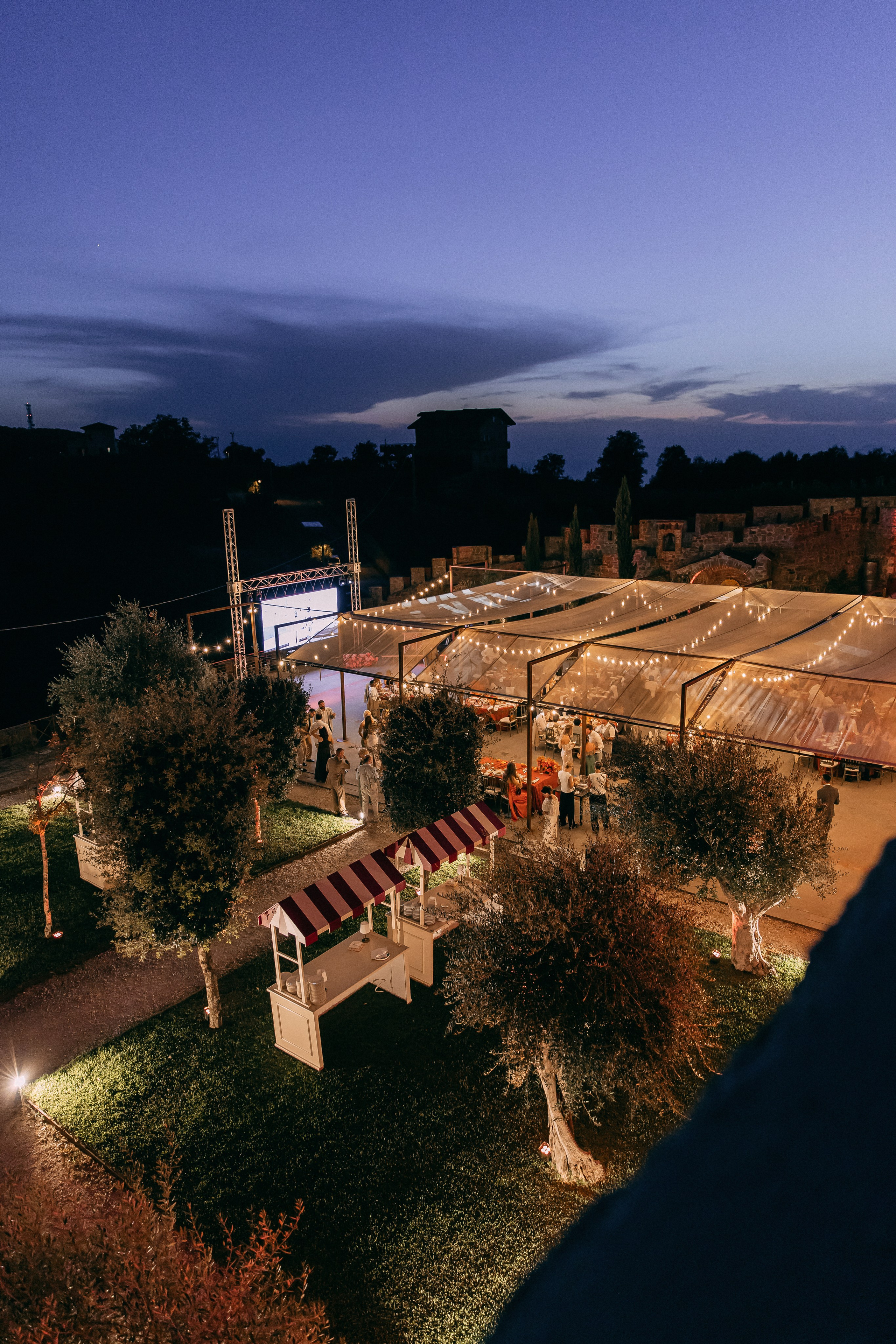 Evening view of the illuminated marquee reception at the castle