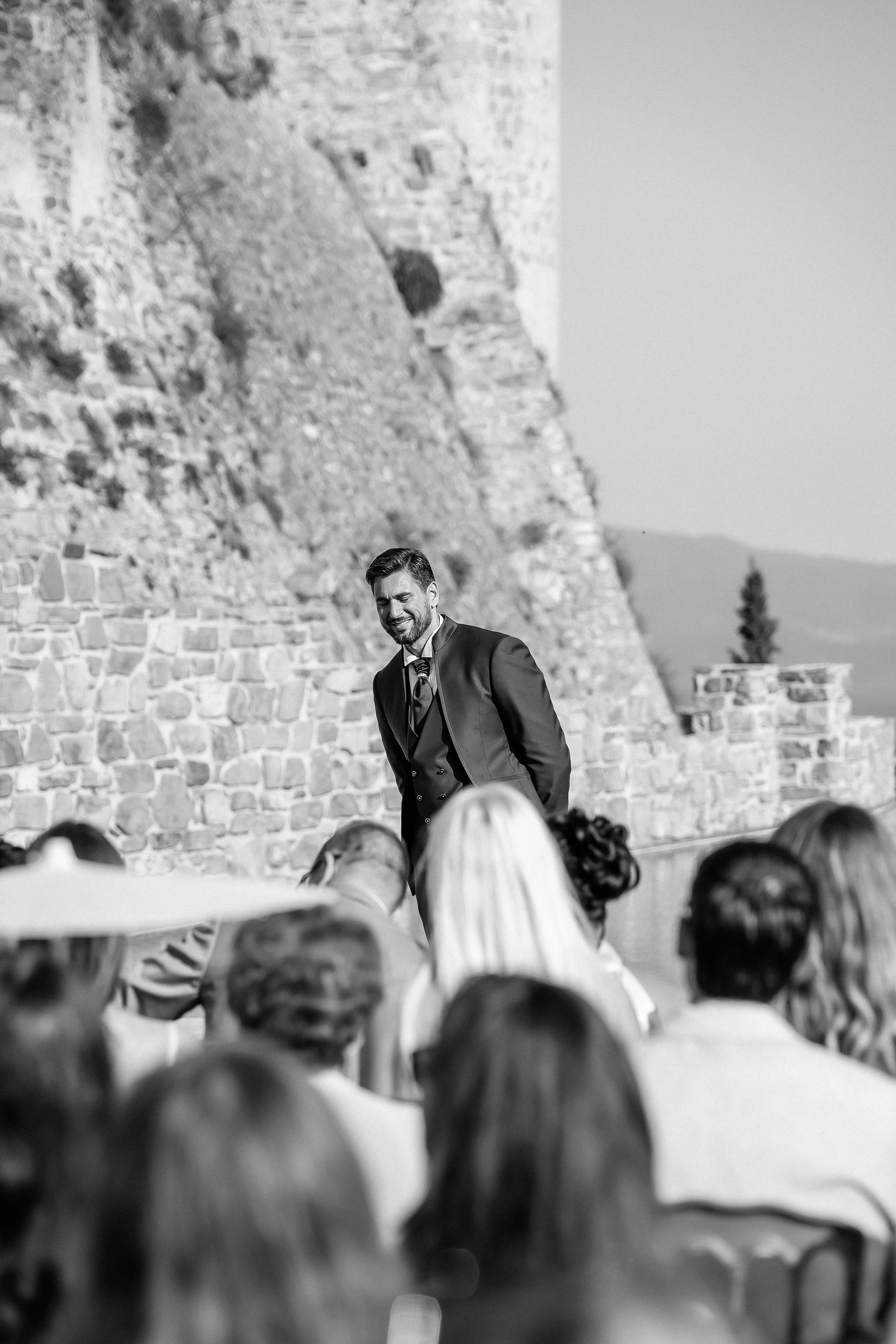Black and white photo of the groom seeing his bride for the first time