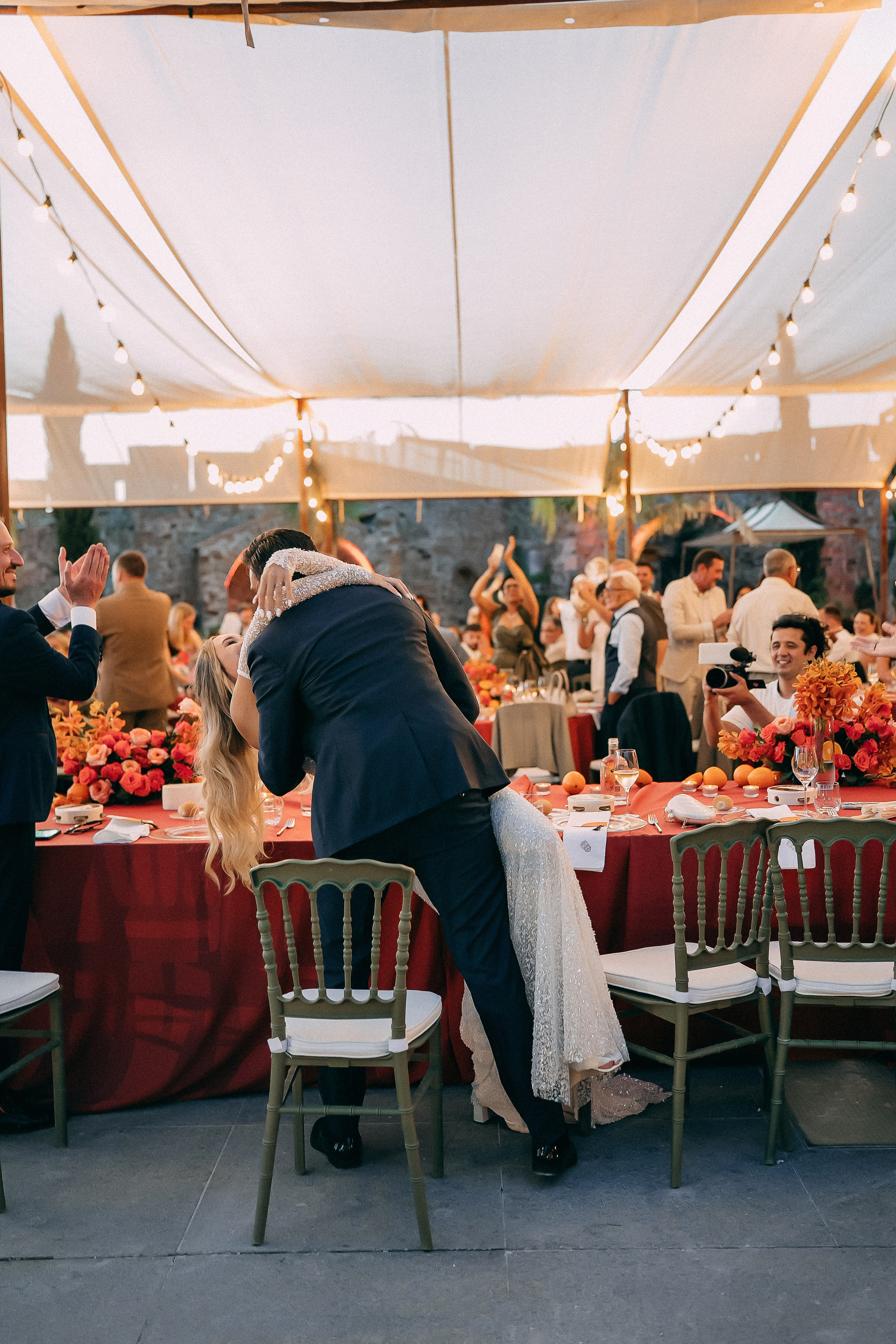 Guests dancing and celebrating under the marquee at the reception