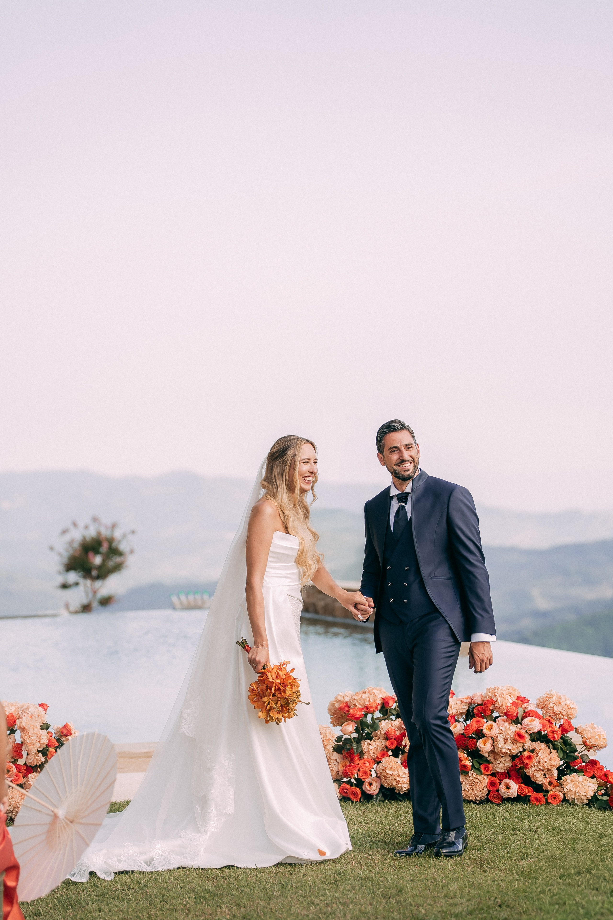 Newlyweds walking hand in hand after the ceremony in Italy