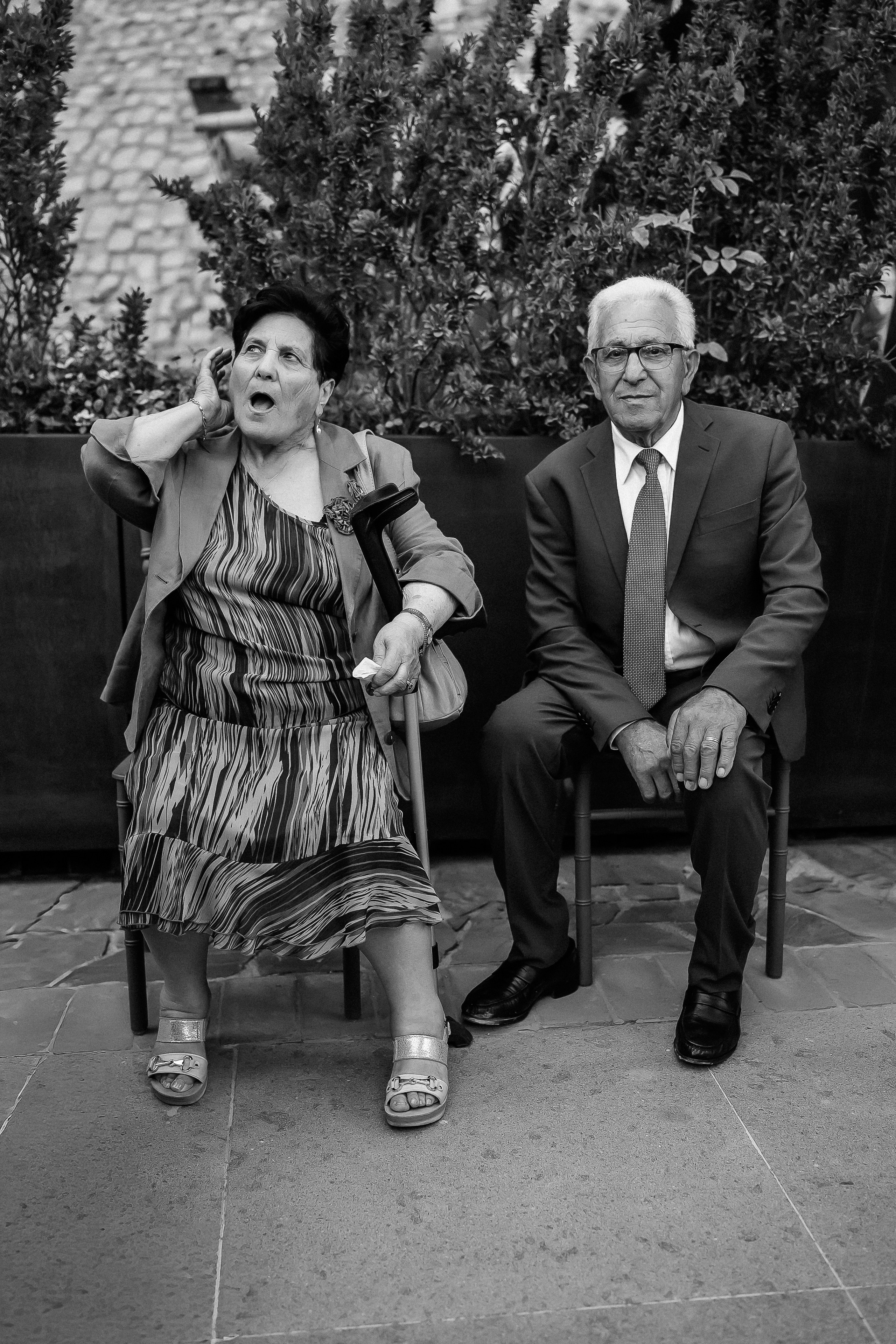 Black and white portrait of elderly guests seated in the castle garden