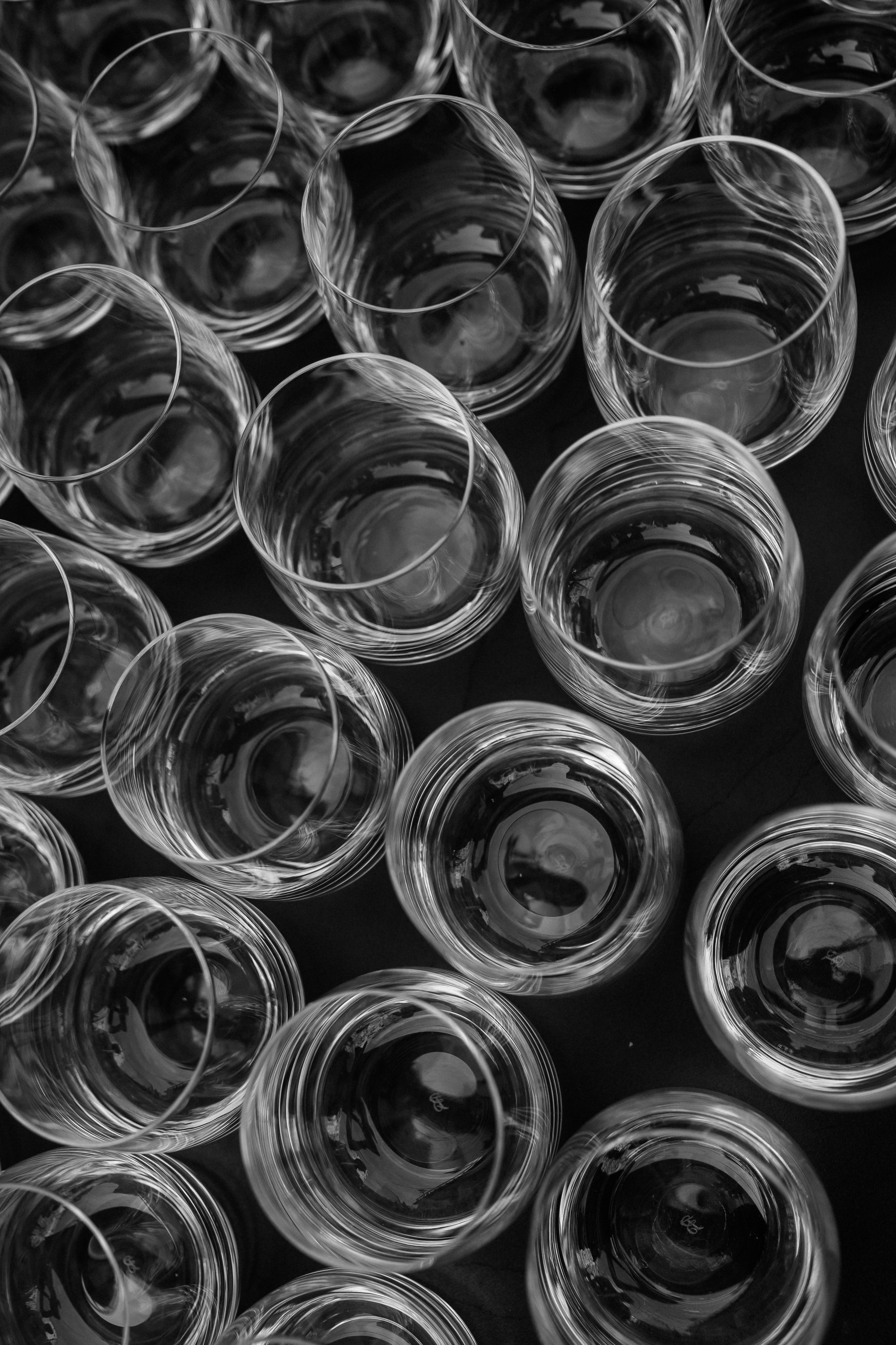 Black and white detail of glasses lined up for the wedding aperitivo