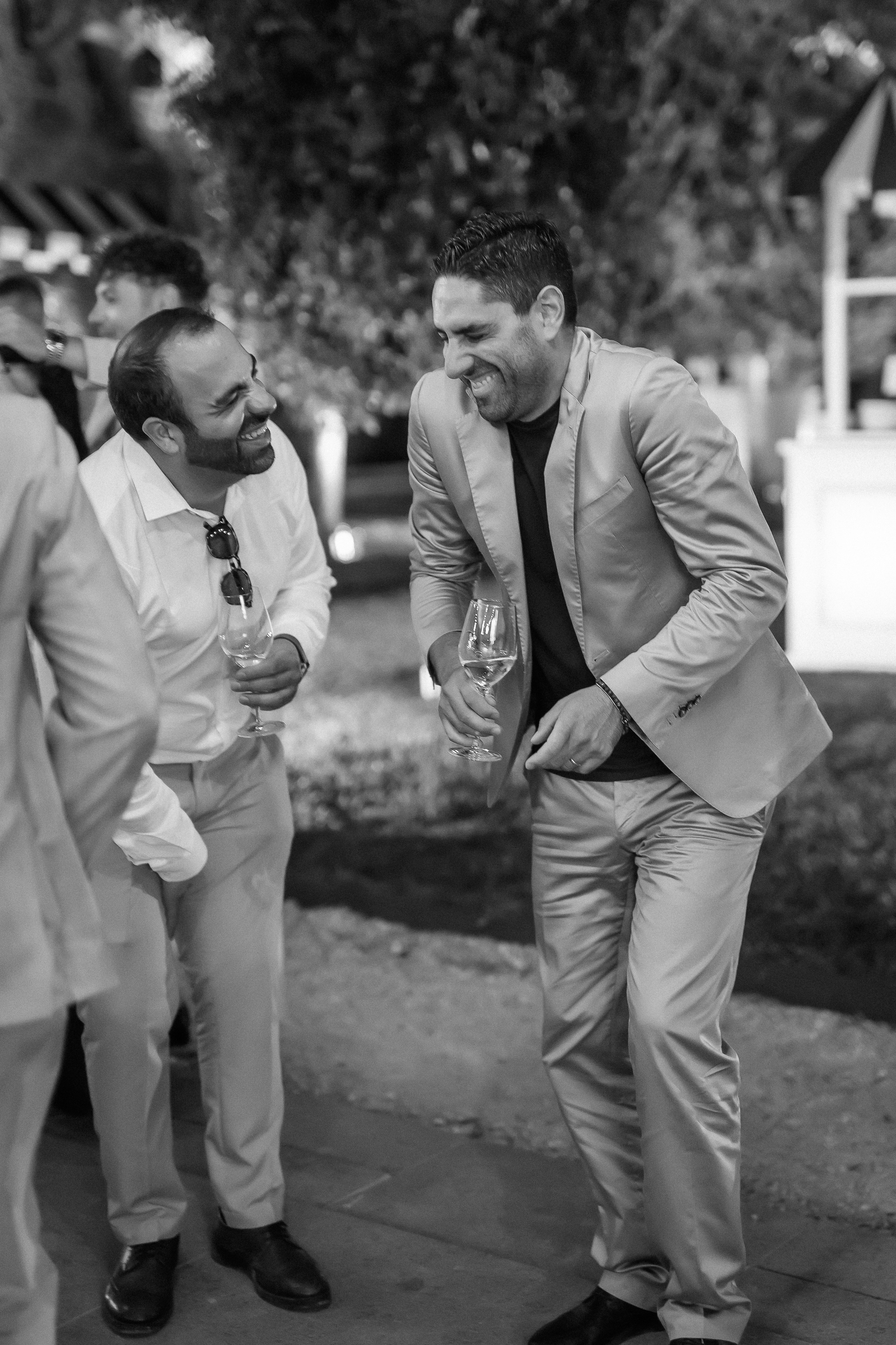 Black and white photo of two guests laughing during the party