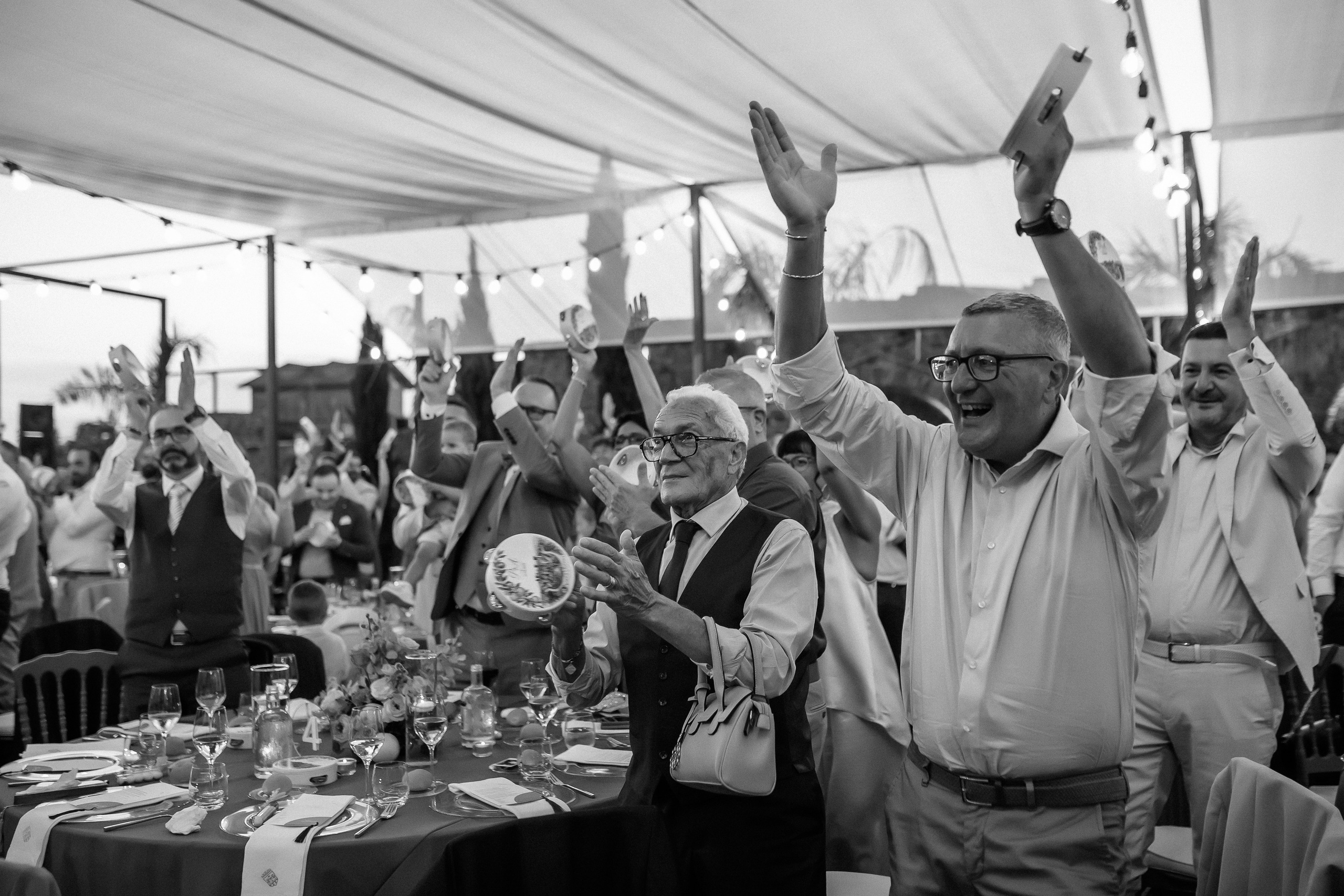 Guests applauding during the speeches at the wedding reception