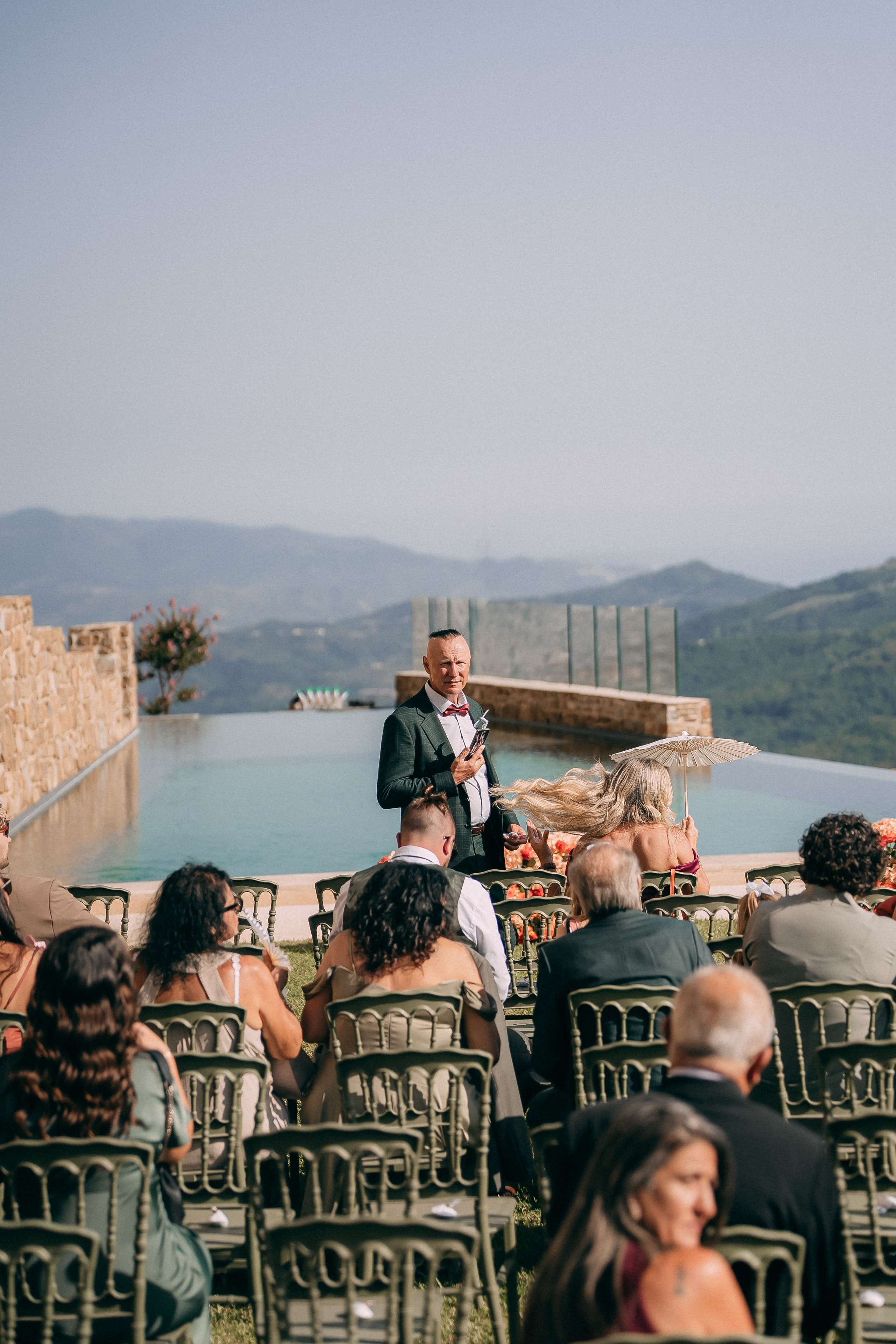 Ceremony setup by the infinity pool with the mountains of Cilento behind
