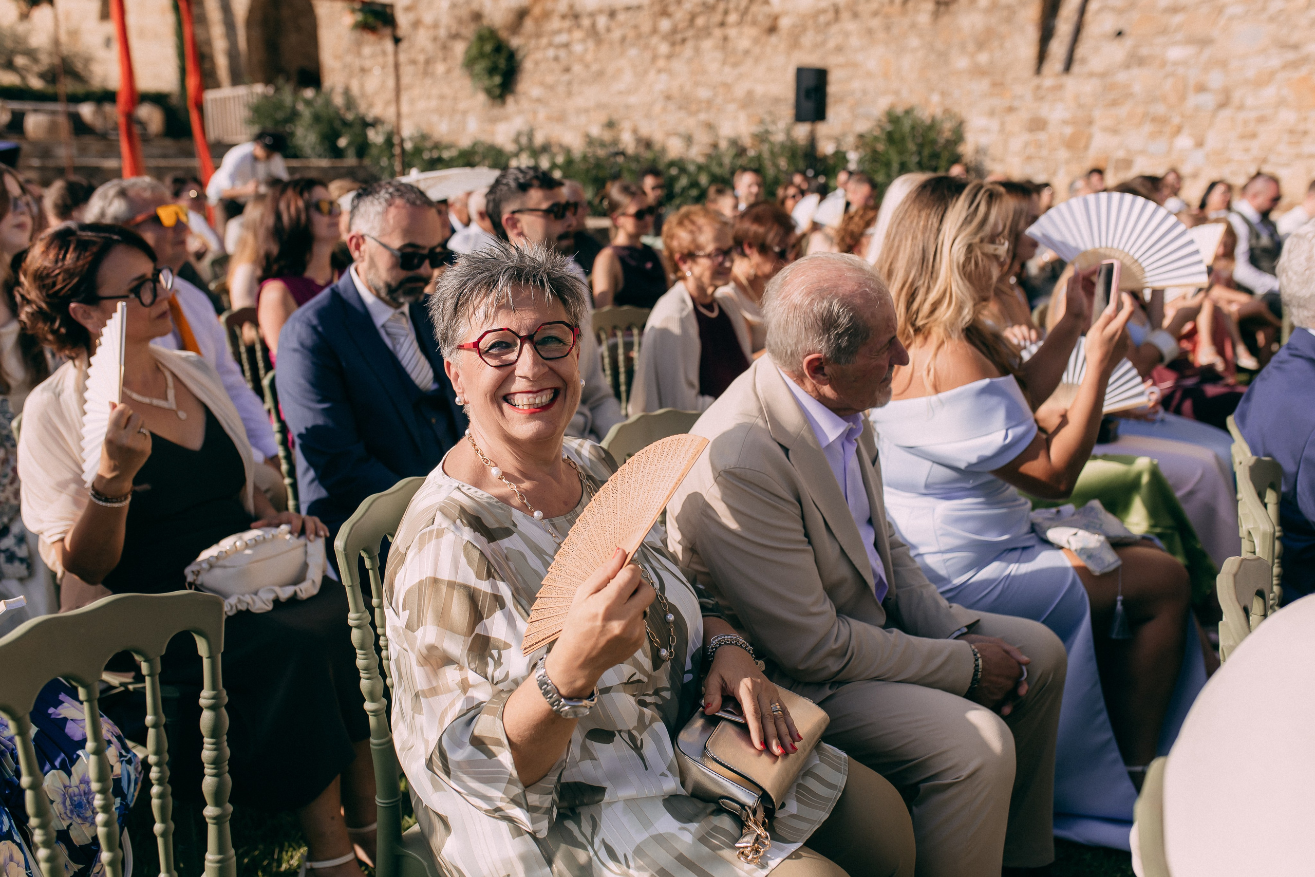 Guests smiling and clapping during the wedding ceremony in Cilento