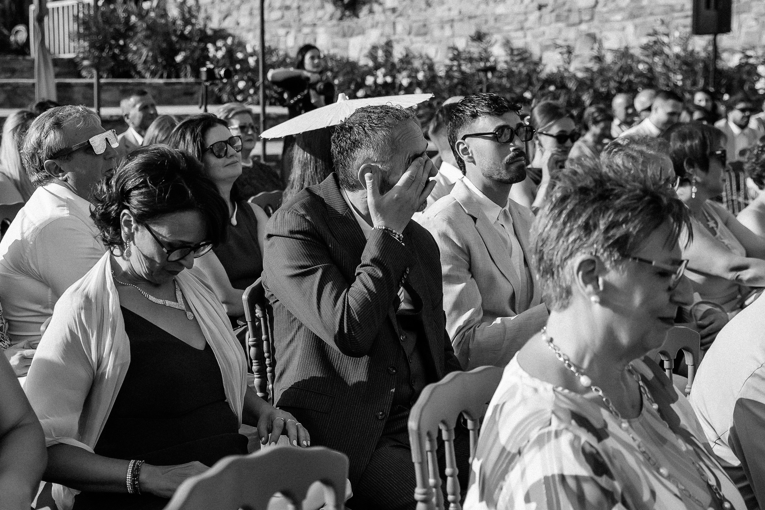 Black and white photo of guests watching the ceremony at the castle