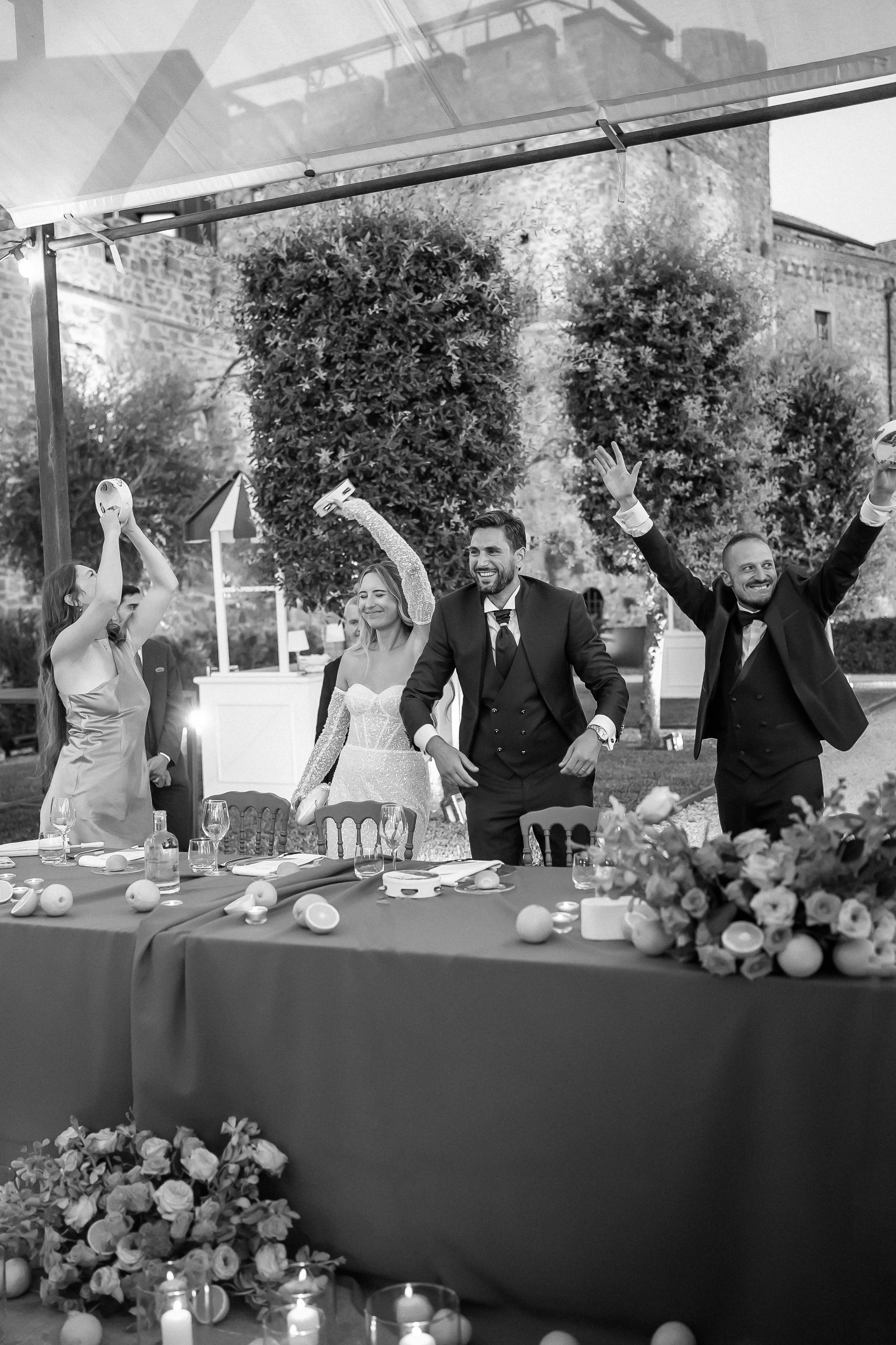 Black and white photo of guests celebrating at the head table