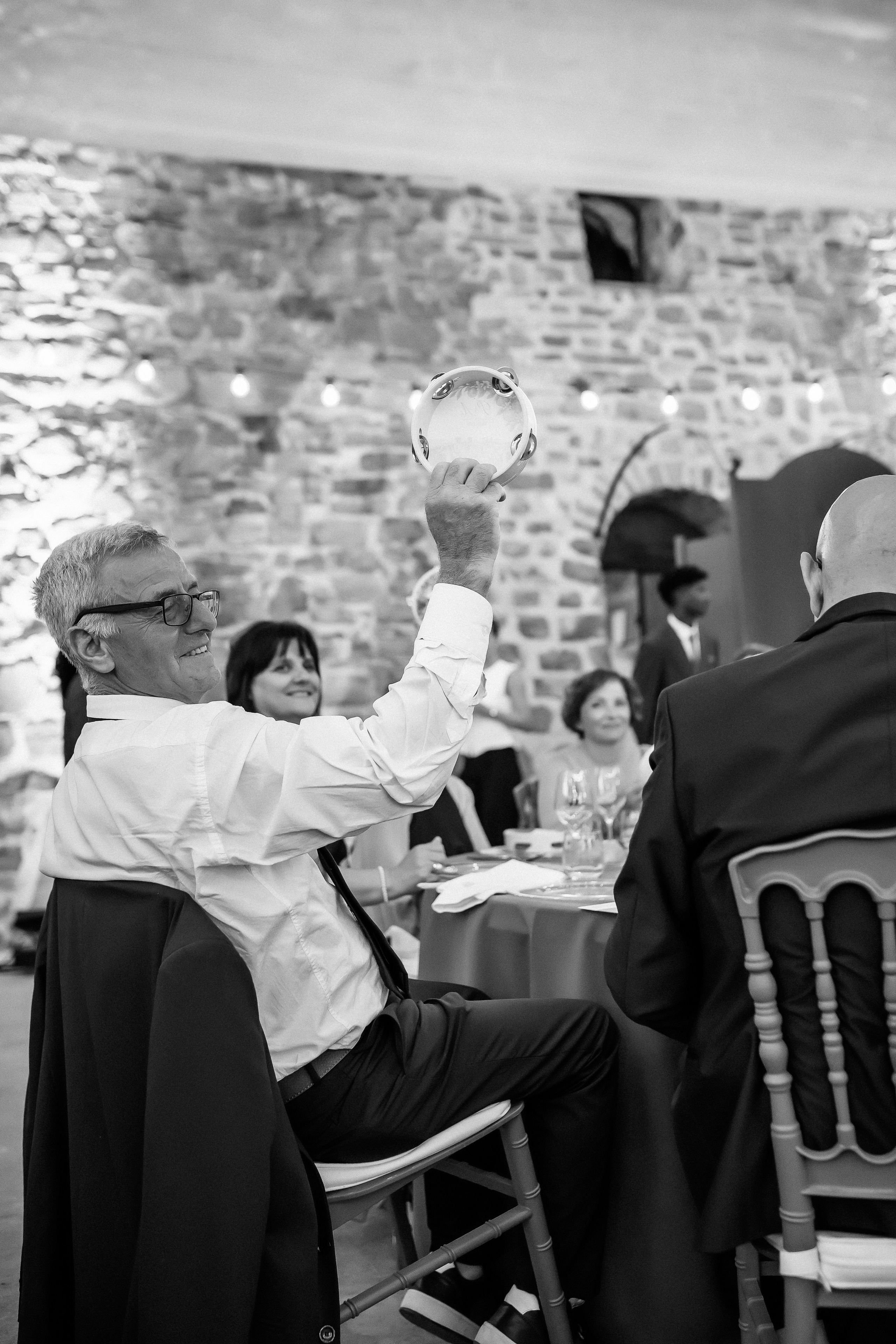 Guest raising his glass for a toast at the wedding dinner