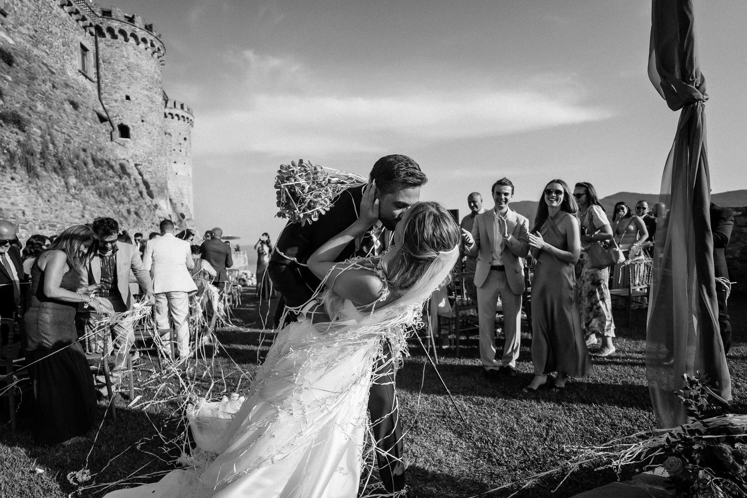Black and white photo of guests congratulating the bride and groom