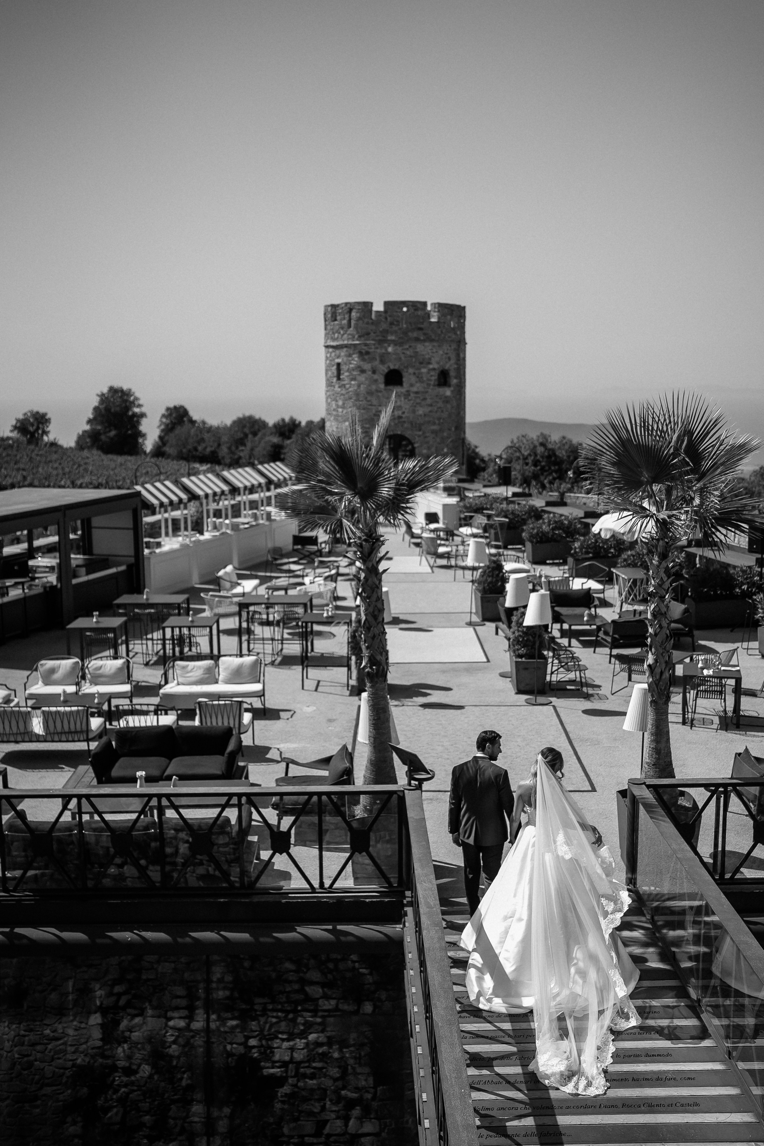 Black and white photo of the bride and groom on the terrace stairs