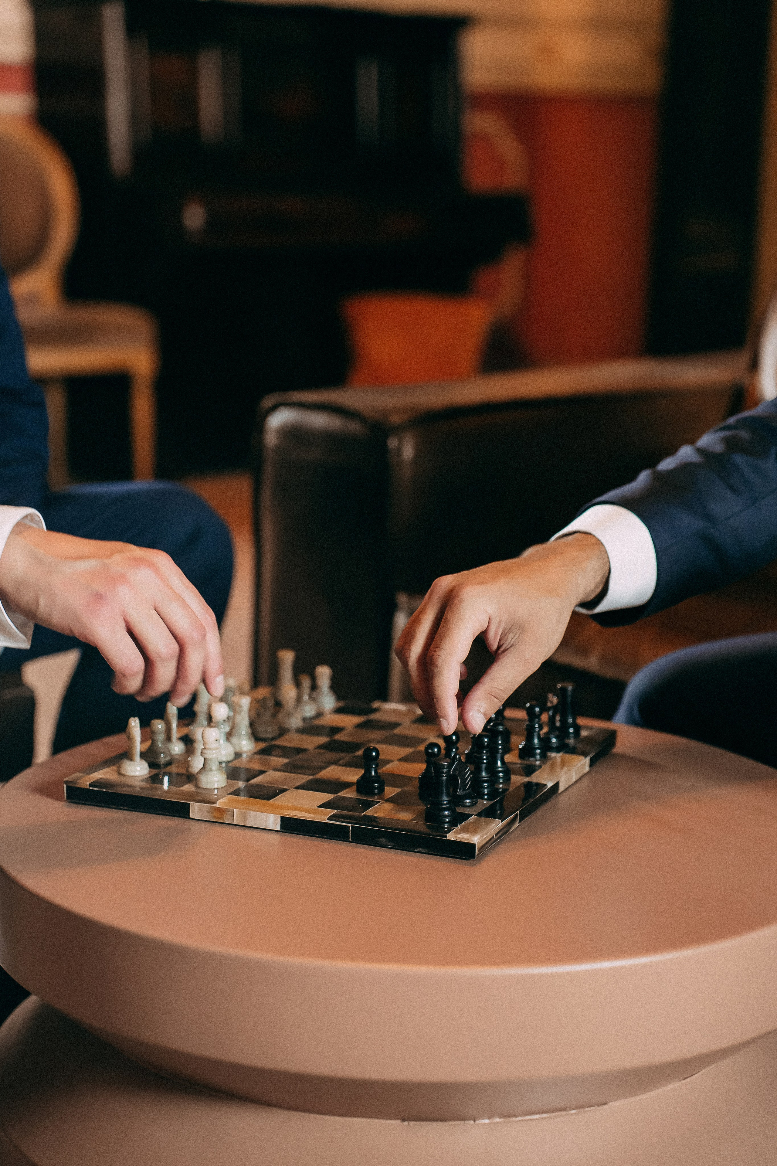 Groom and his friends playing chess while waiting for the ceremony