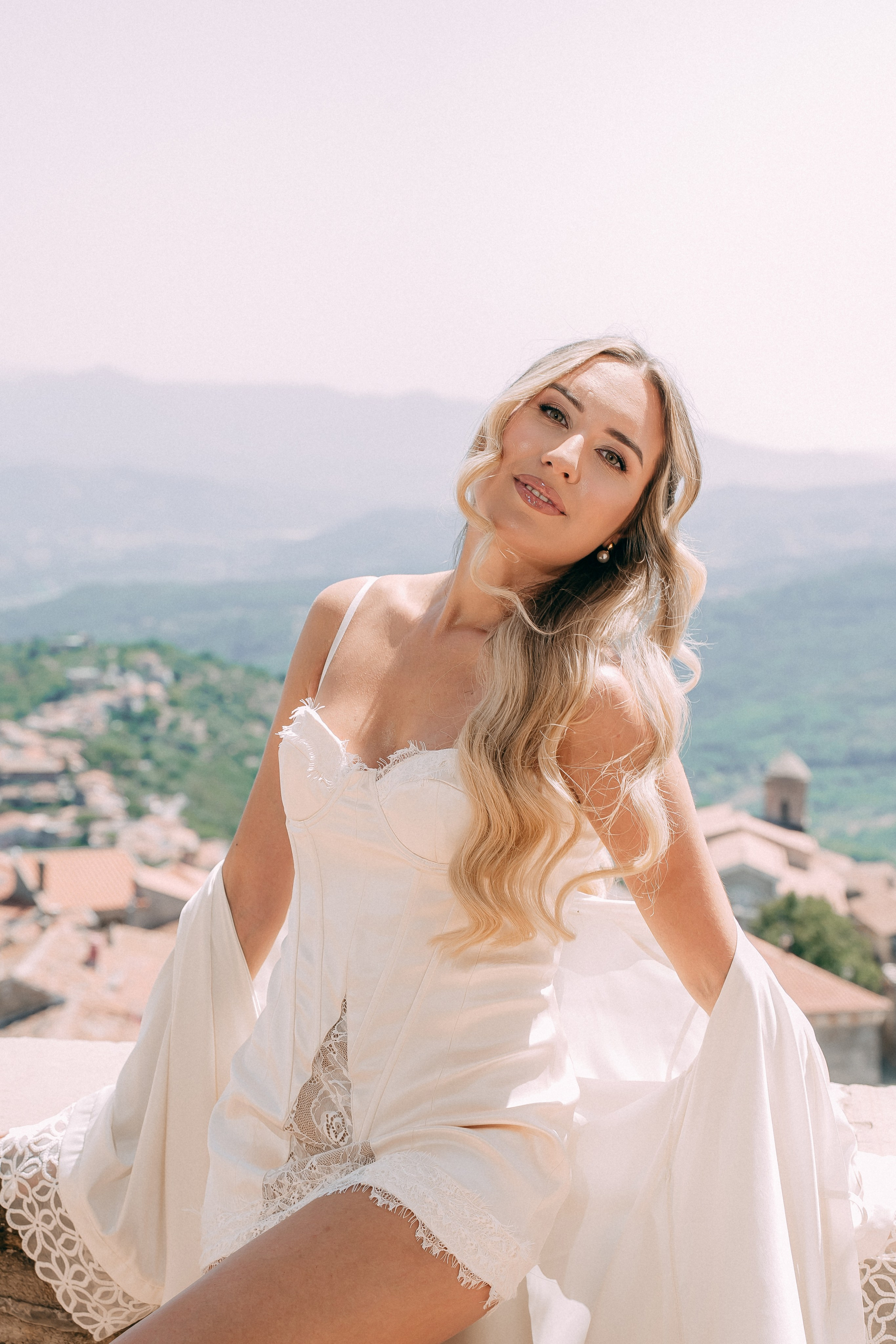Portrait of the bride with wavy blonde hair in a silk slip dress
