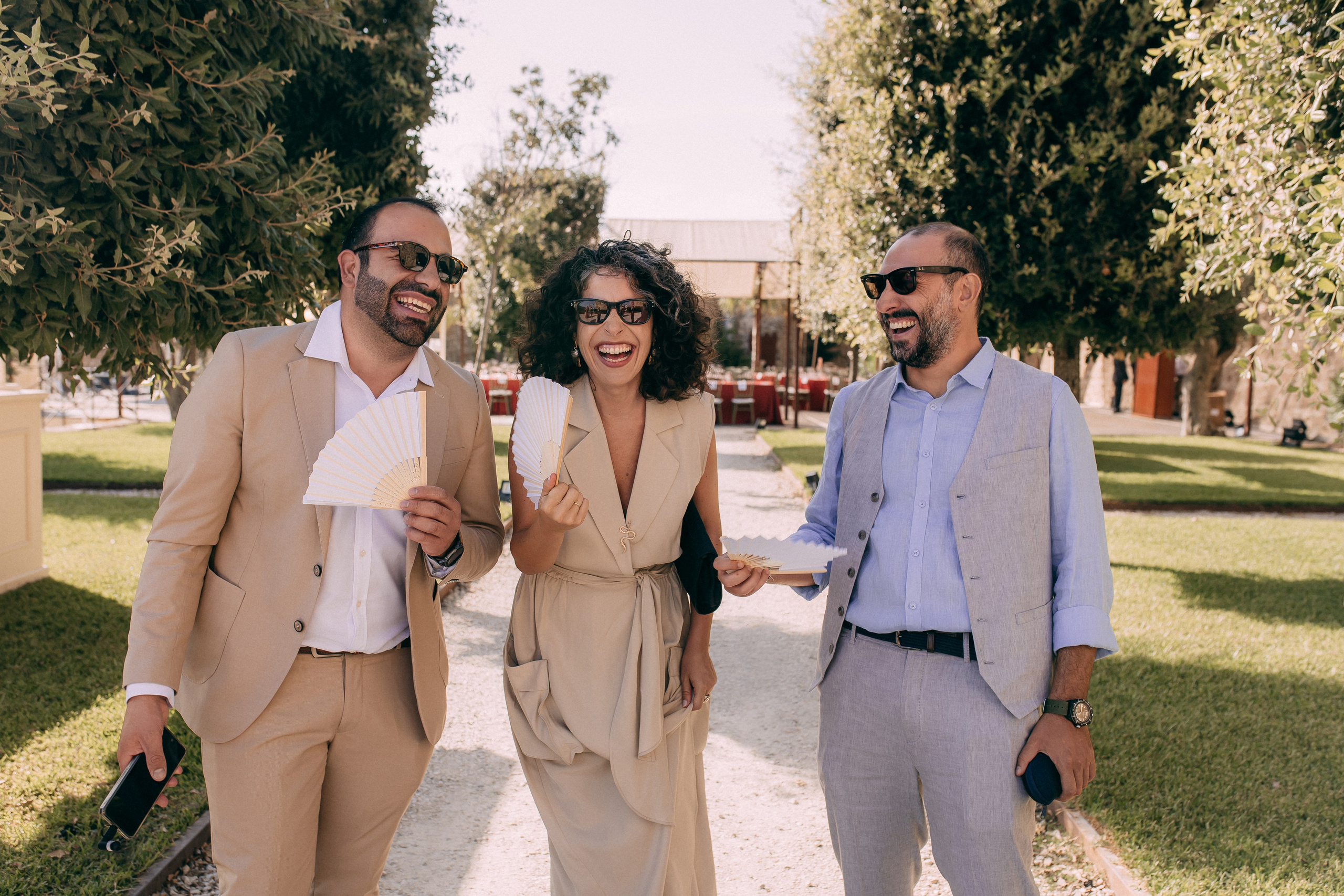 Wedding guests walking to the ceremony in the castle garden