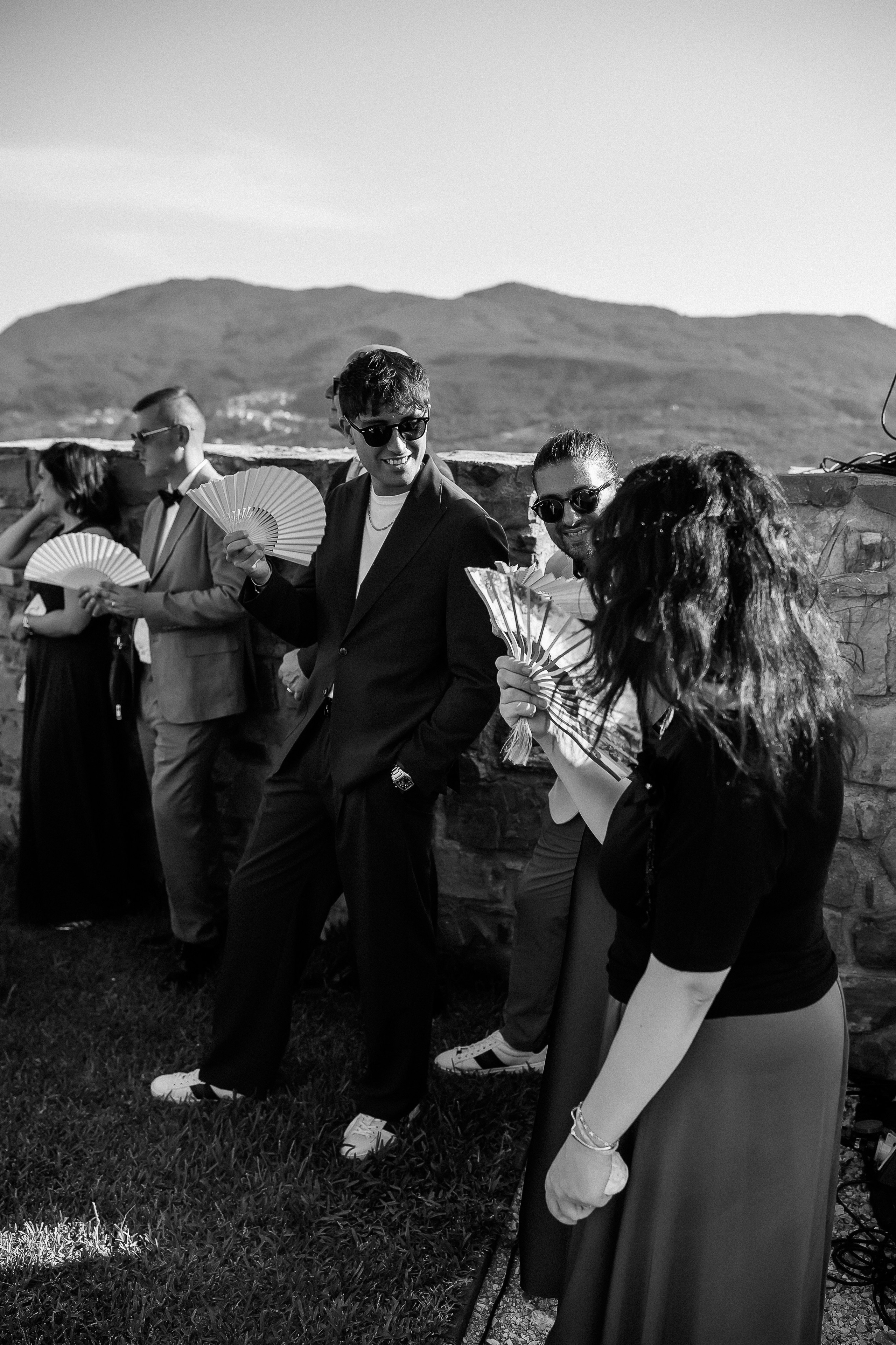 Black and white photo of guests greeting each other before the ceremony