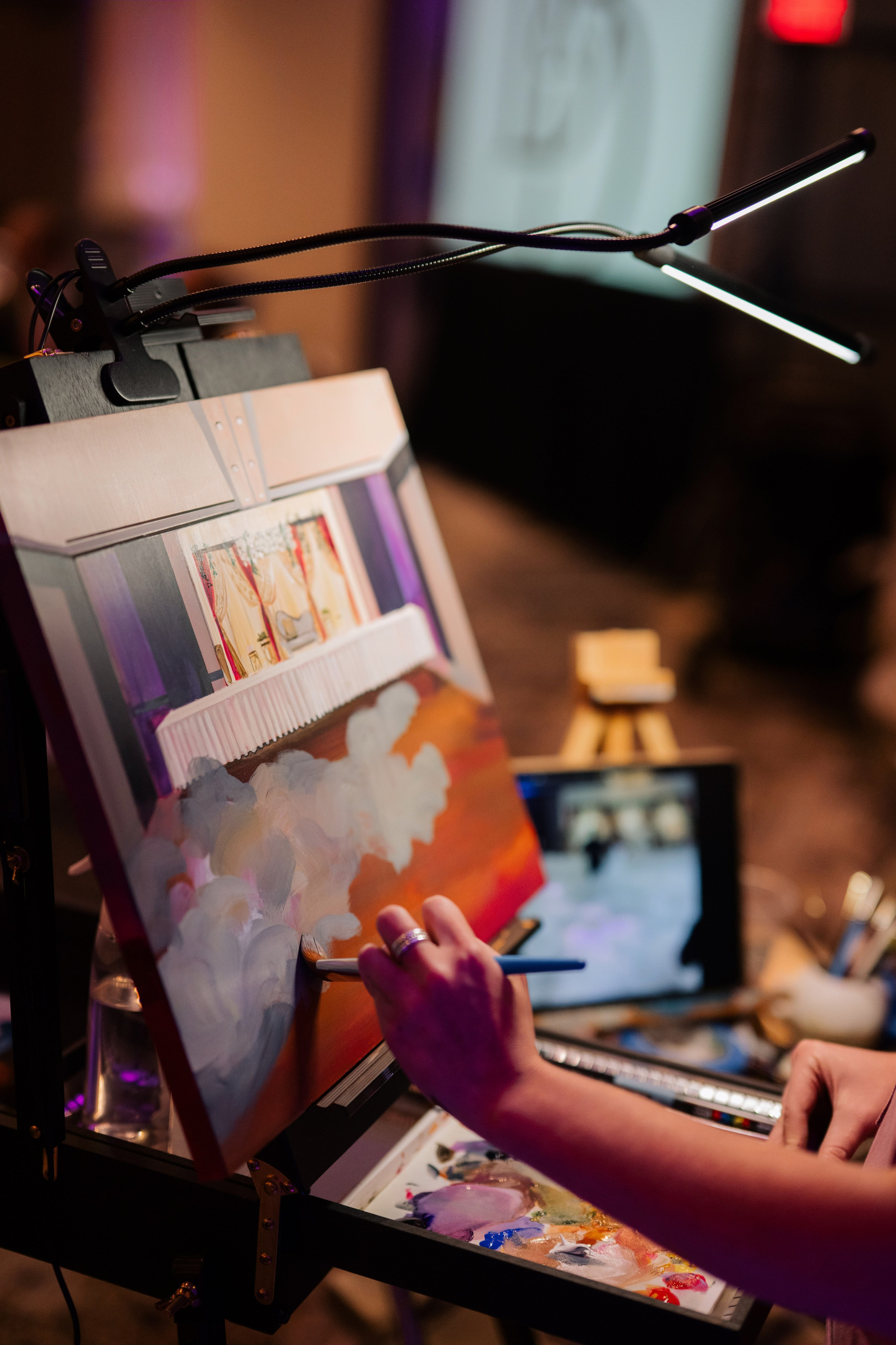 a person is painting a picture on a ease