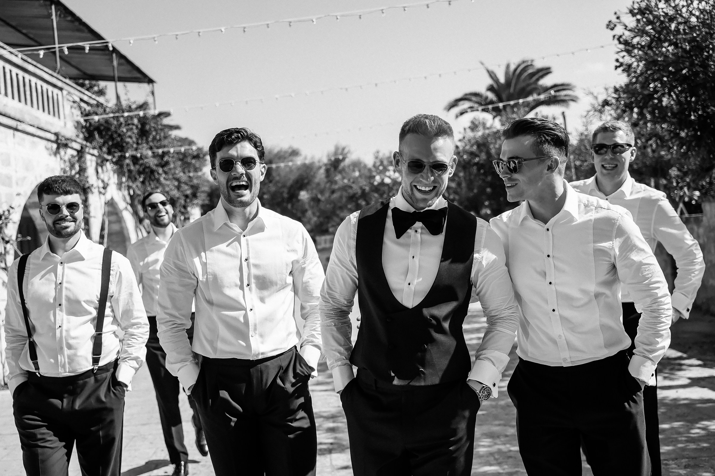 A close-up of the groomsmen walking and laughing together, exuding camaraderie and anticipation for the big day.