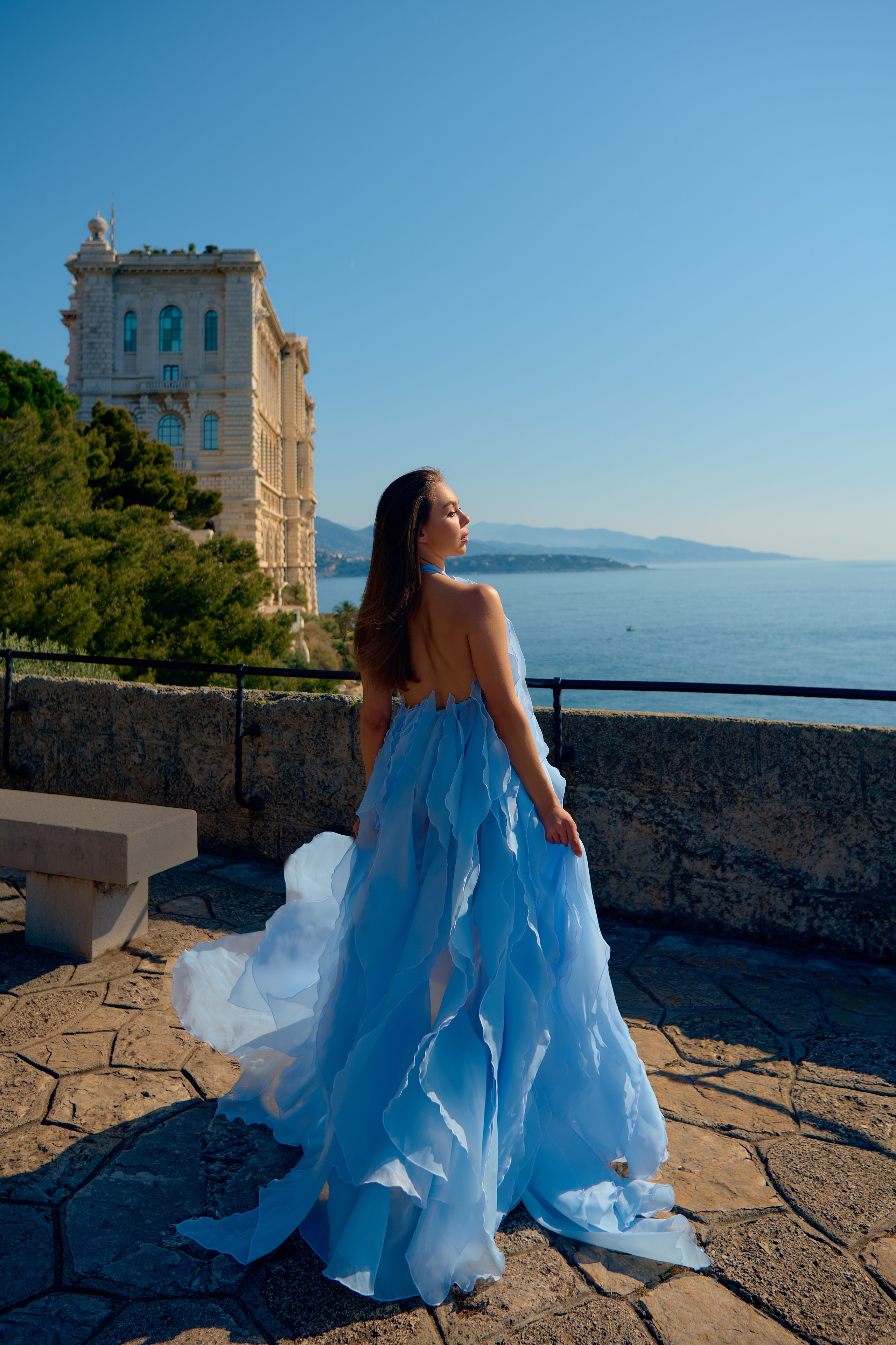 High-end fashion portrait of woman in blue dress under natural light Monaco