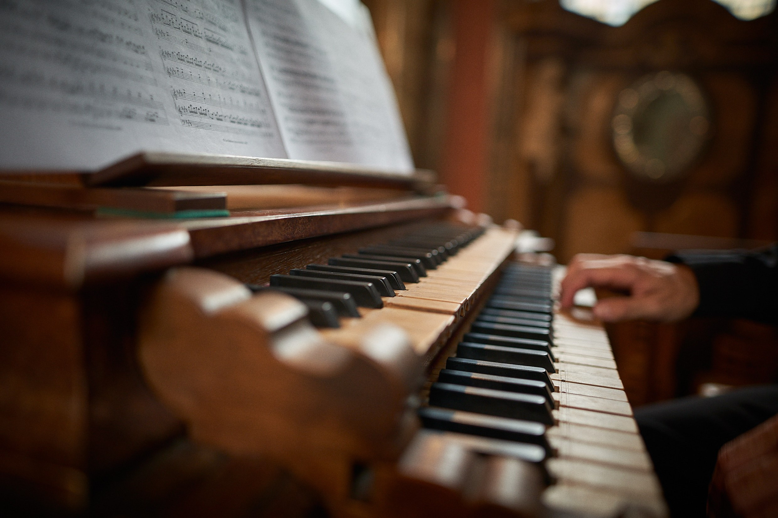Musician preparing grand organ in baroque Klementinum Mirror Chapel.