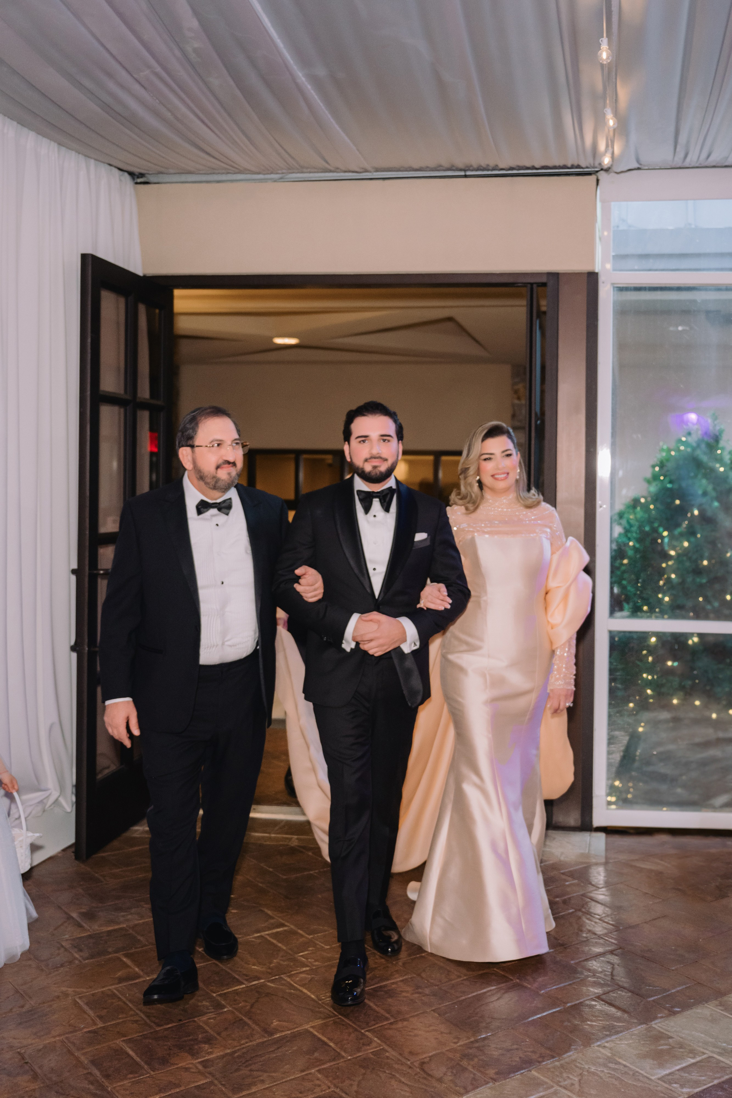 a man and woman walking down a hall