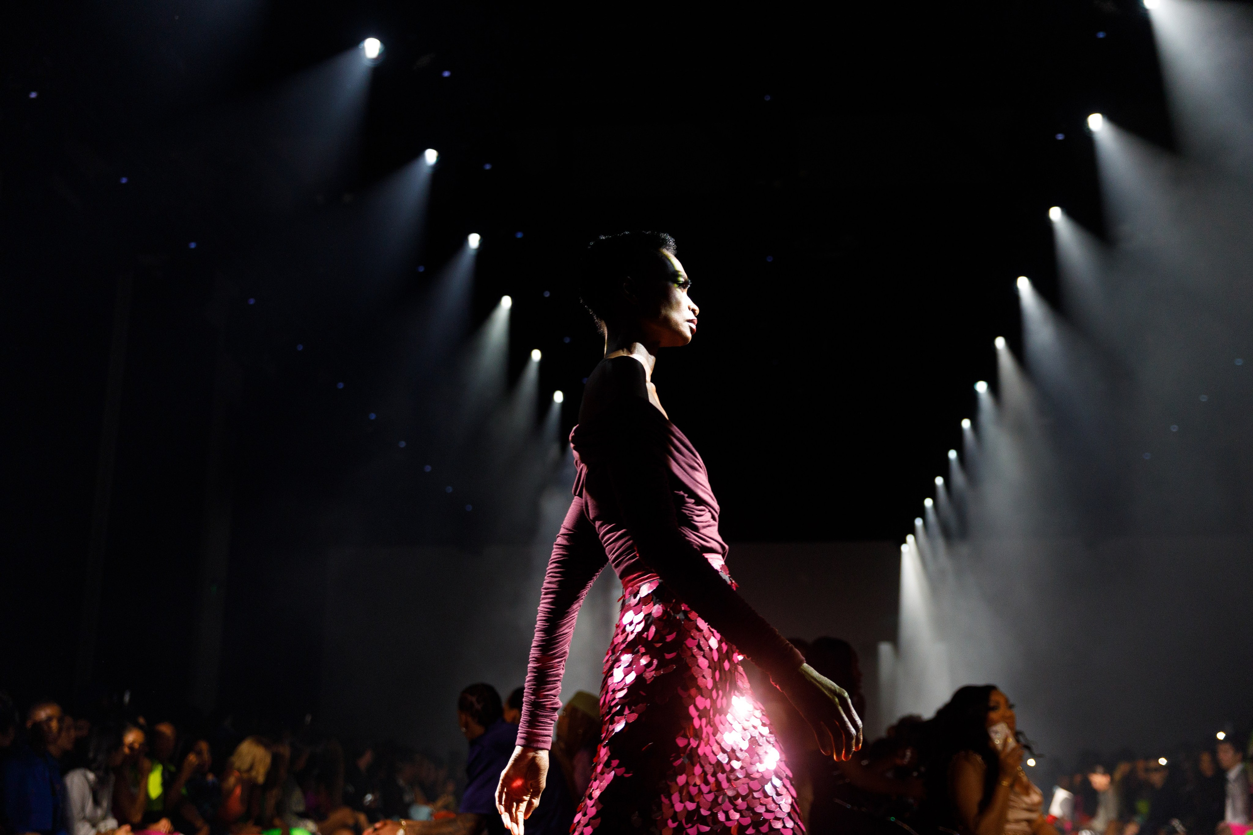 Runway model in sequin gown from behind – couture runway moment