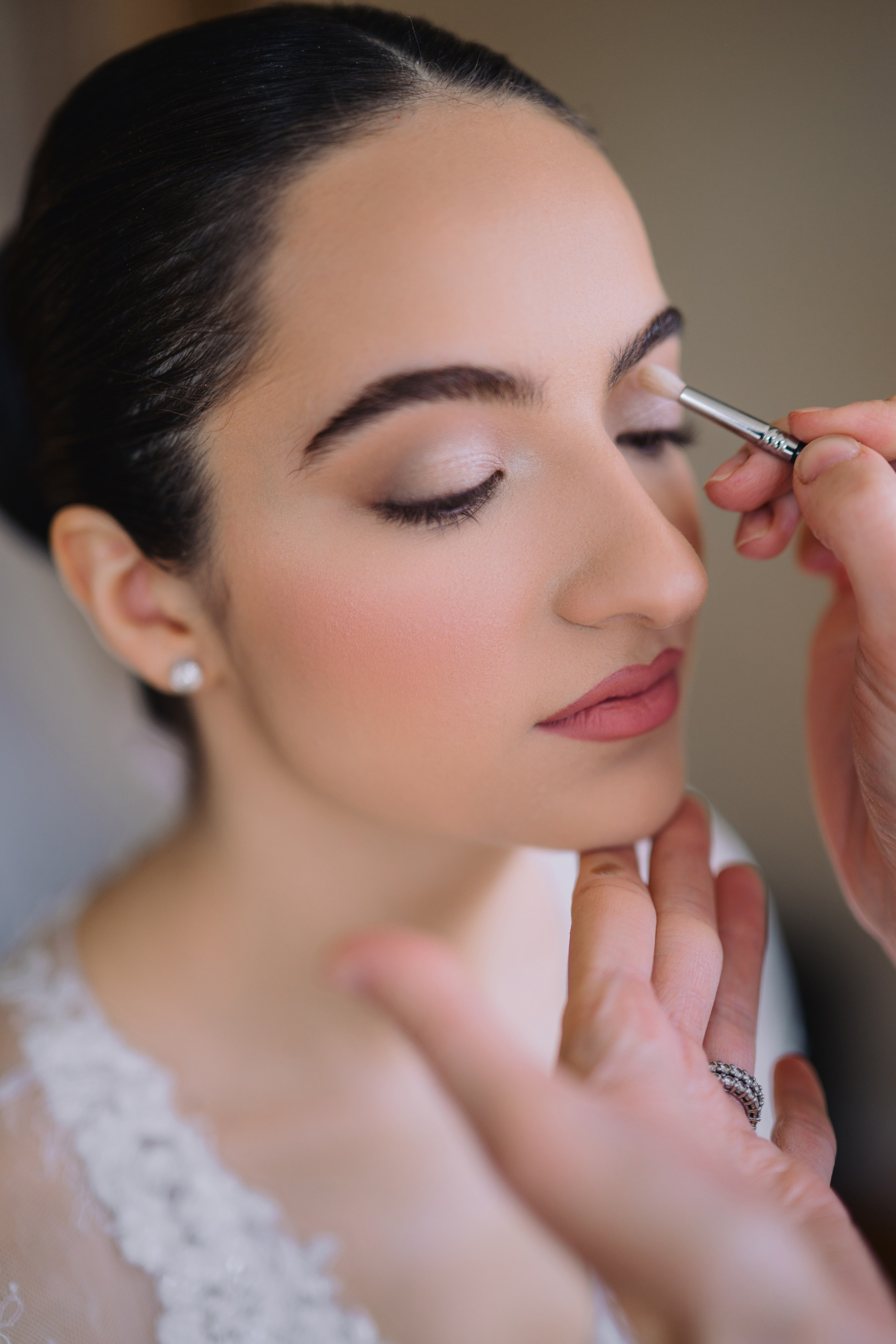 a woman is putting her make up