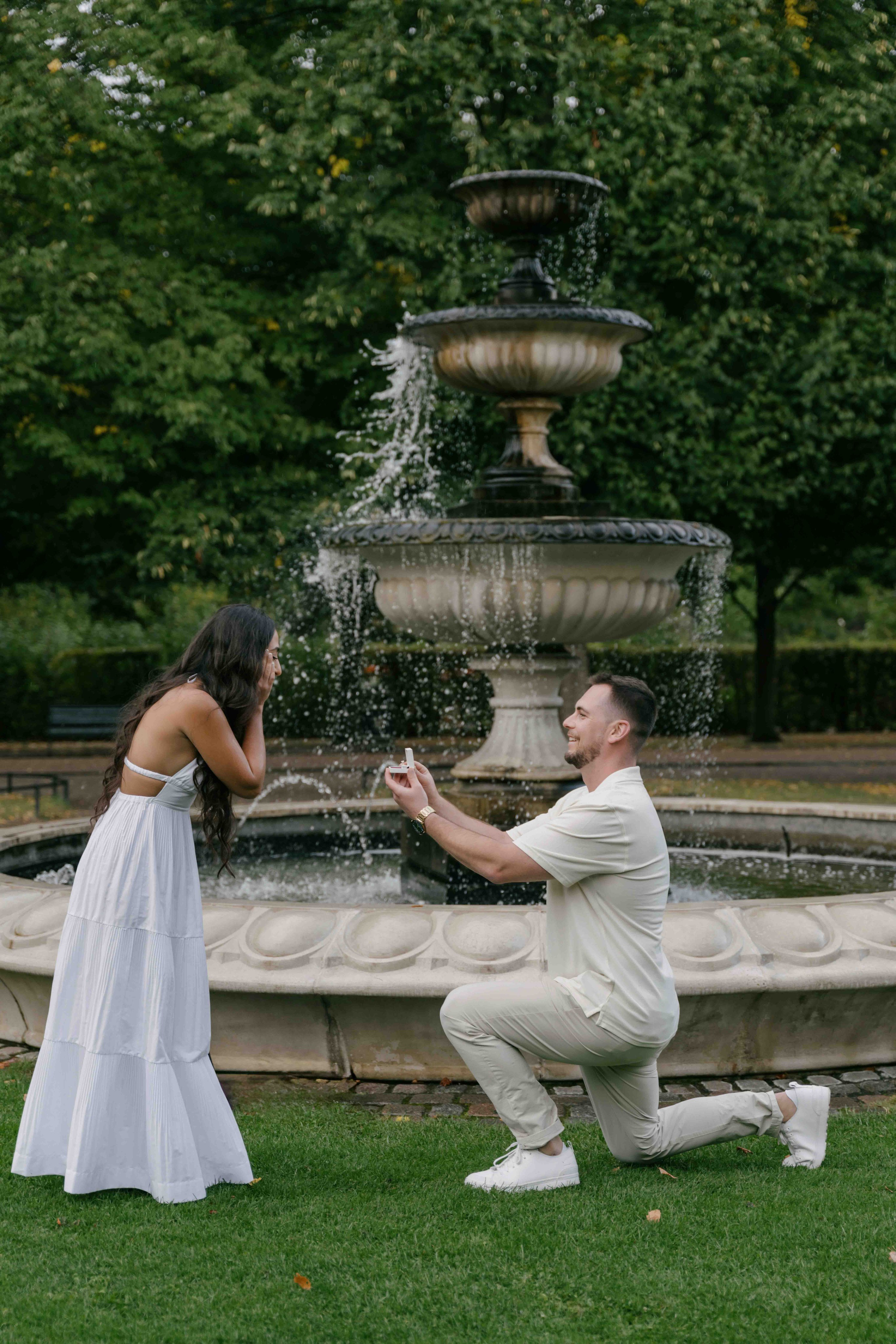 Man proposing on one knee in Regent’s Park London, romantic engagement moment after rain