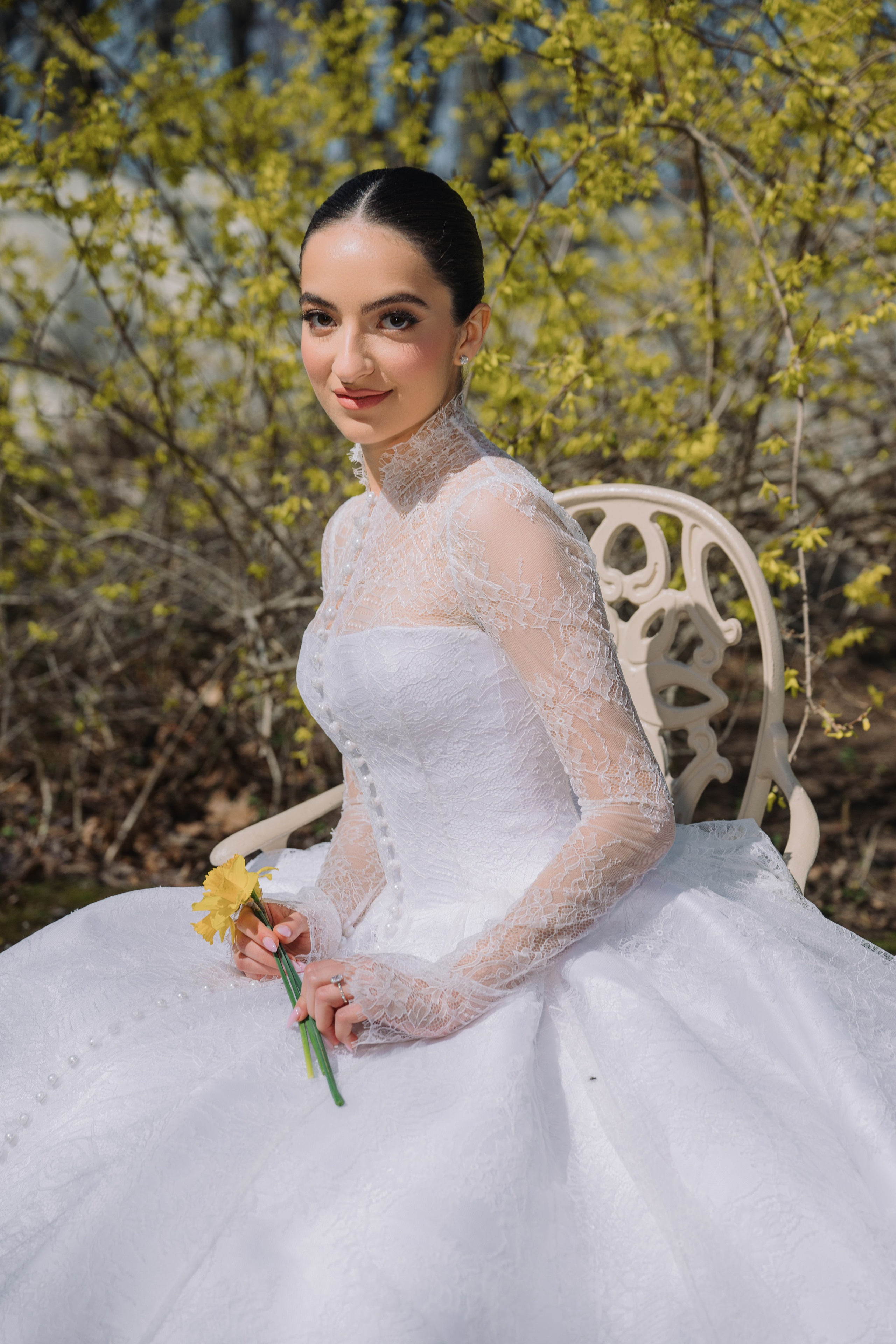a woman in a white wedding dress sitting on a bench