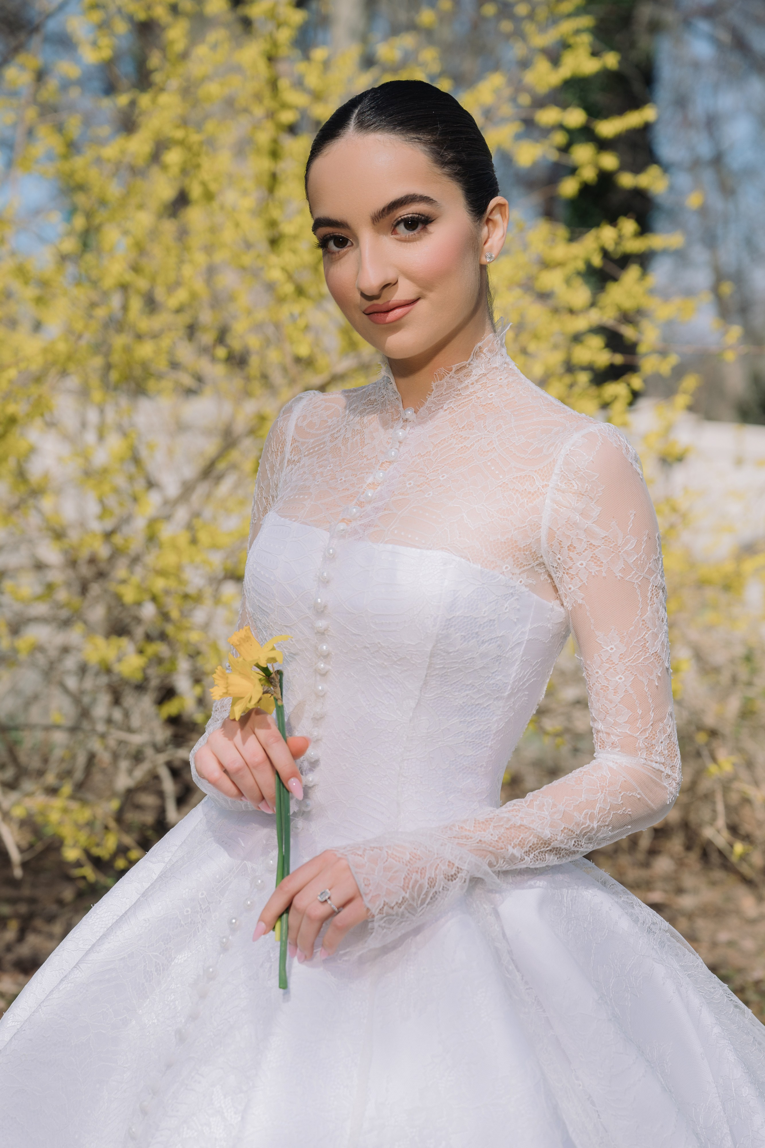 a woman in a white dress holding a flower