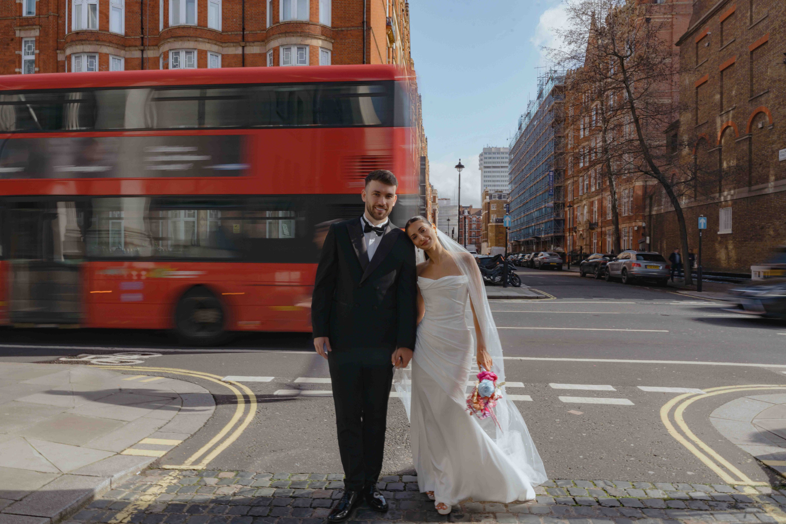 London wedding couple with red bus Marylebone cinematic city wedding photography iconic London moment UK