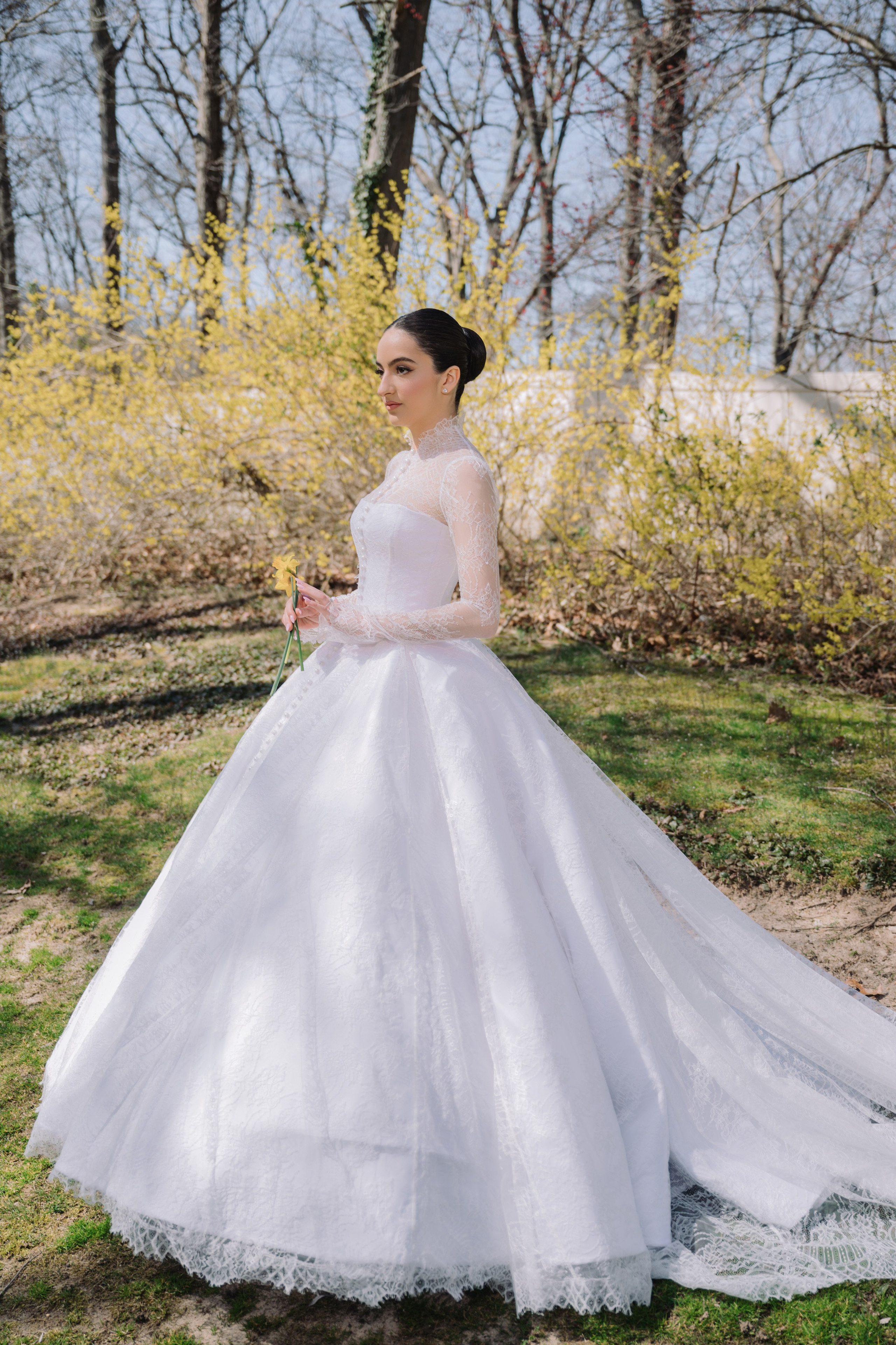 a bride in a white wedding dress standing in the grass