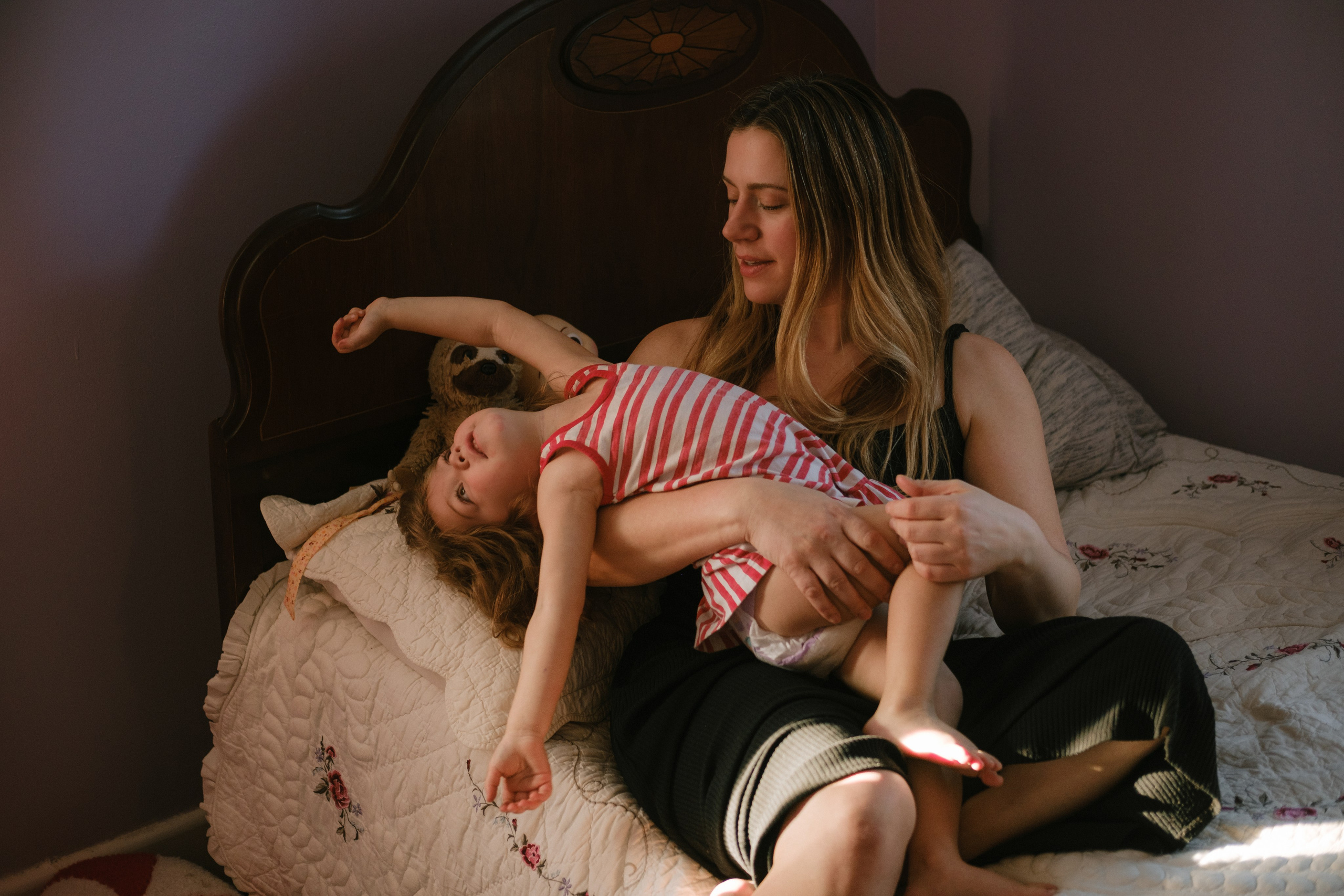 Close-up of a child’s small hand resting on a parent’s shoulder, artistic lifestyle photography focusing on connection and touch.