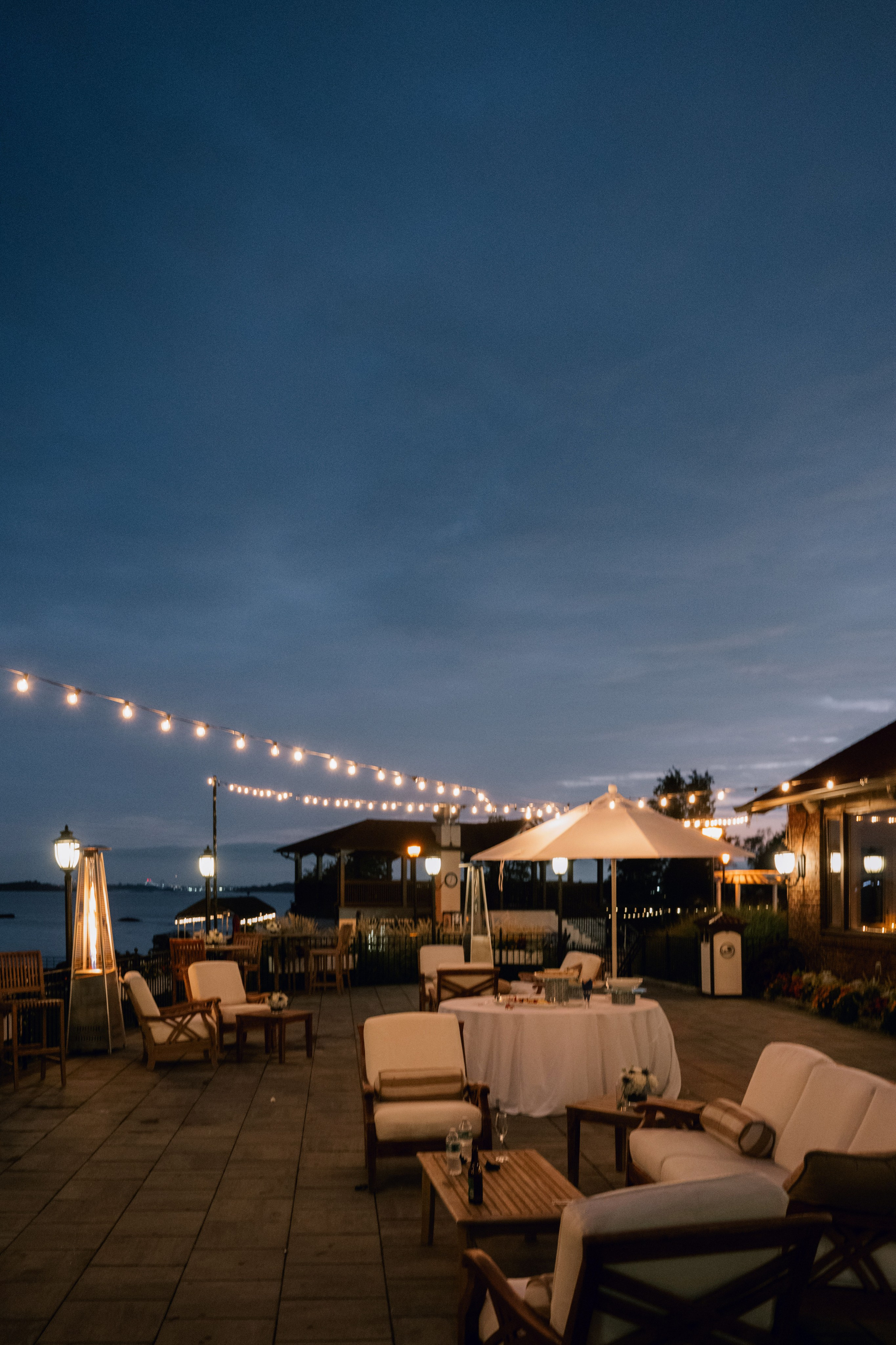 a patio with tables and chairs and lights