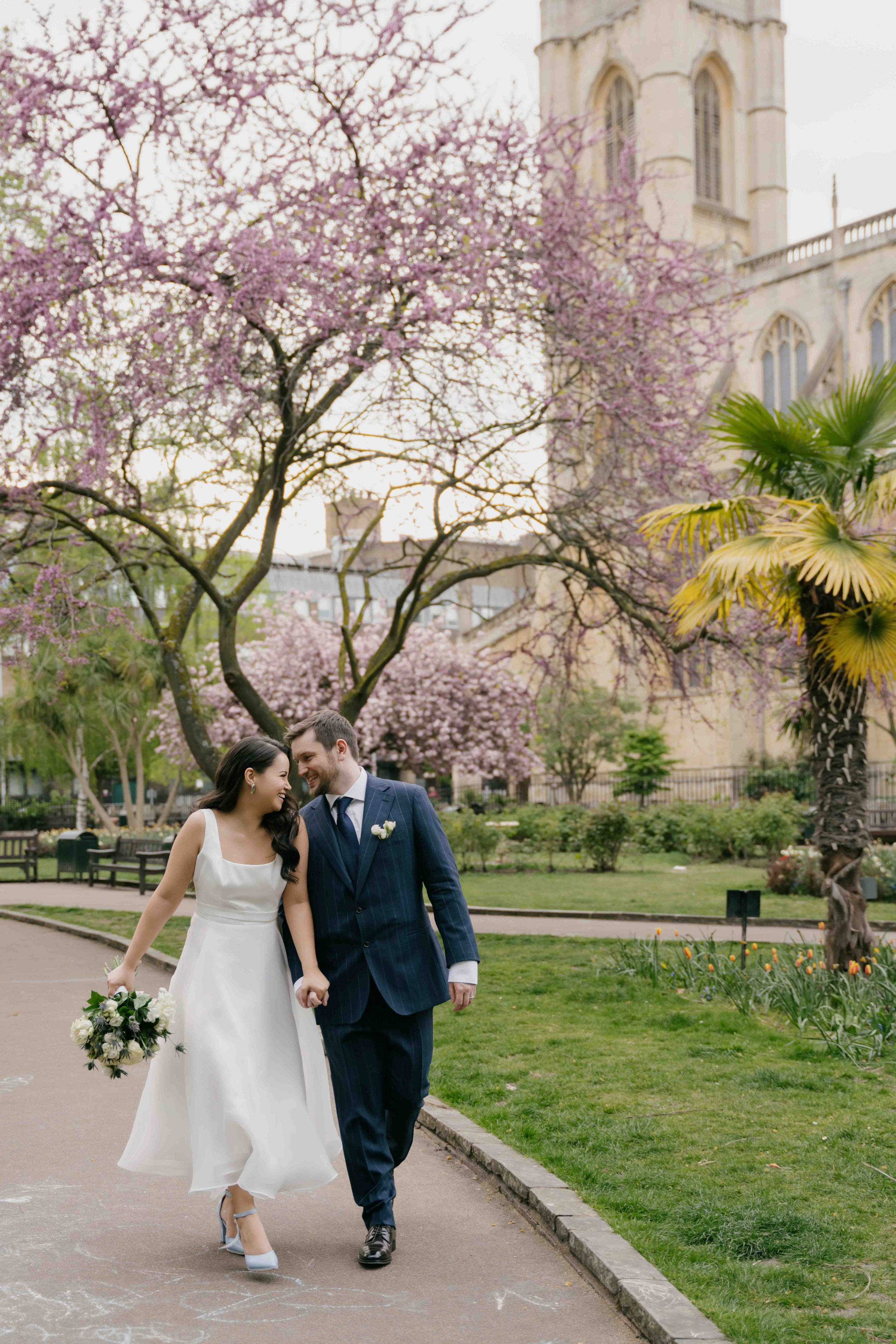 Bride and groom under cherry blossom in London, Chelsea wedding photography, elegant and timeless style