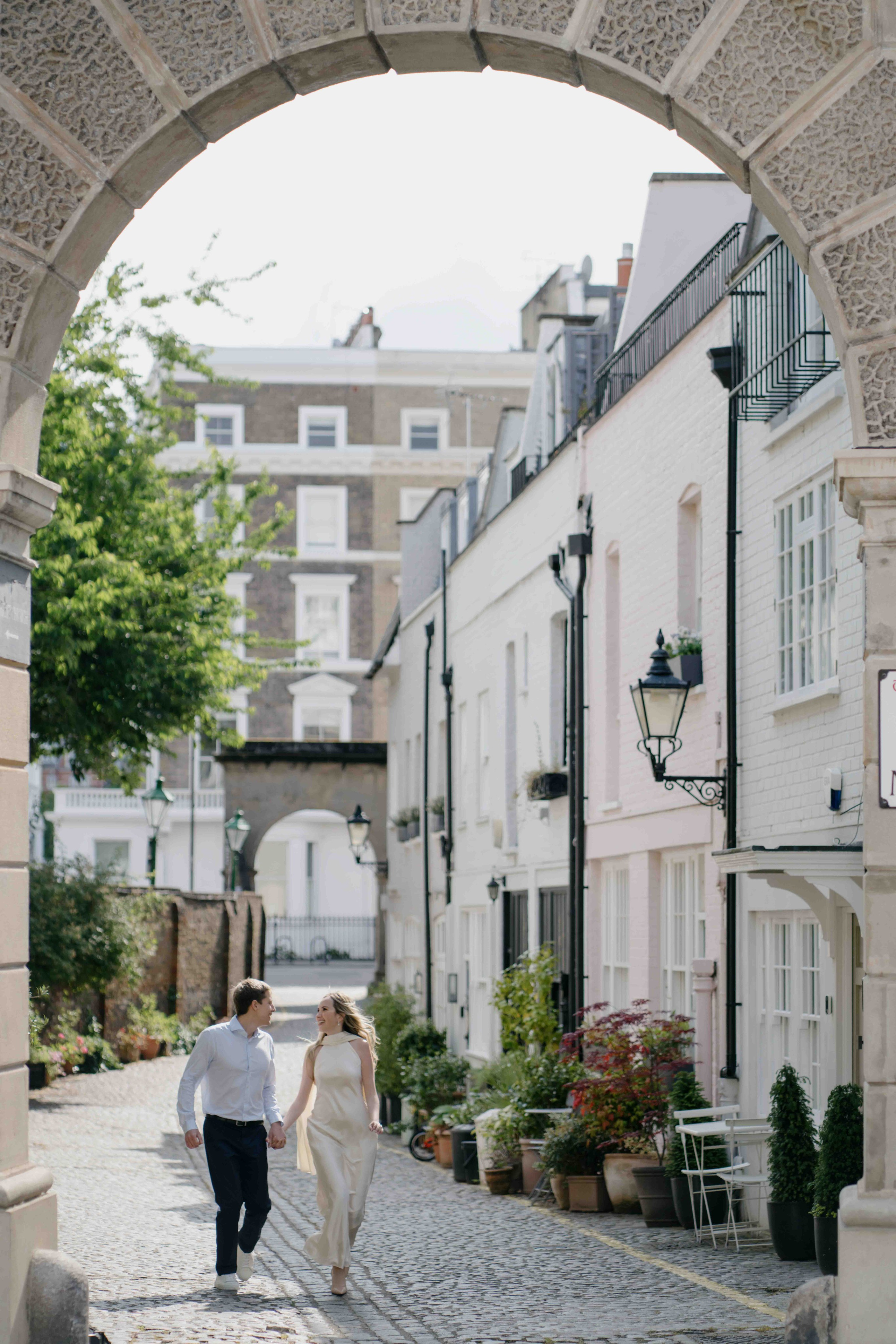 Couple walking through a quiet mews street in South Kensington London