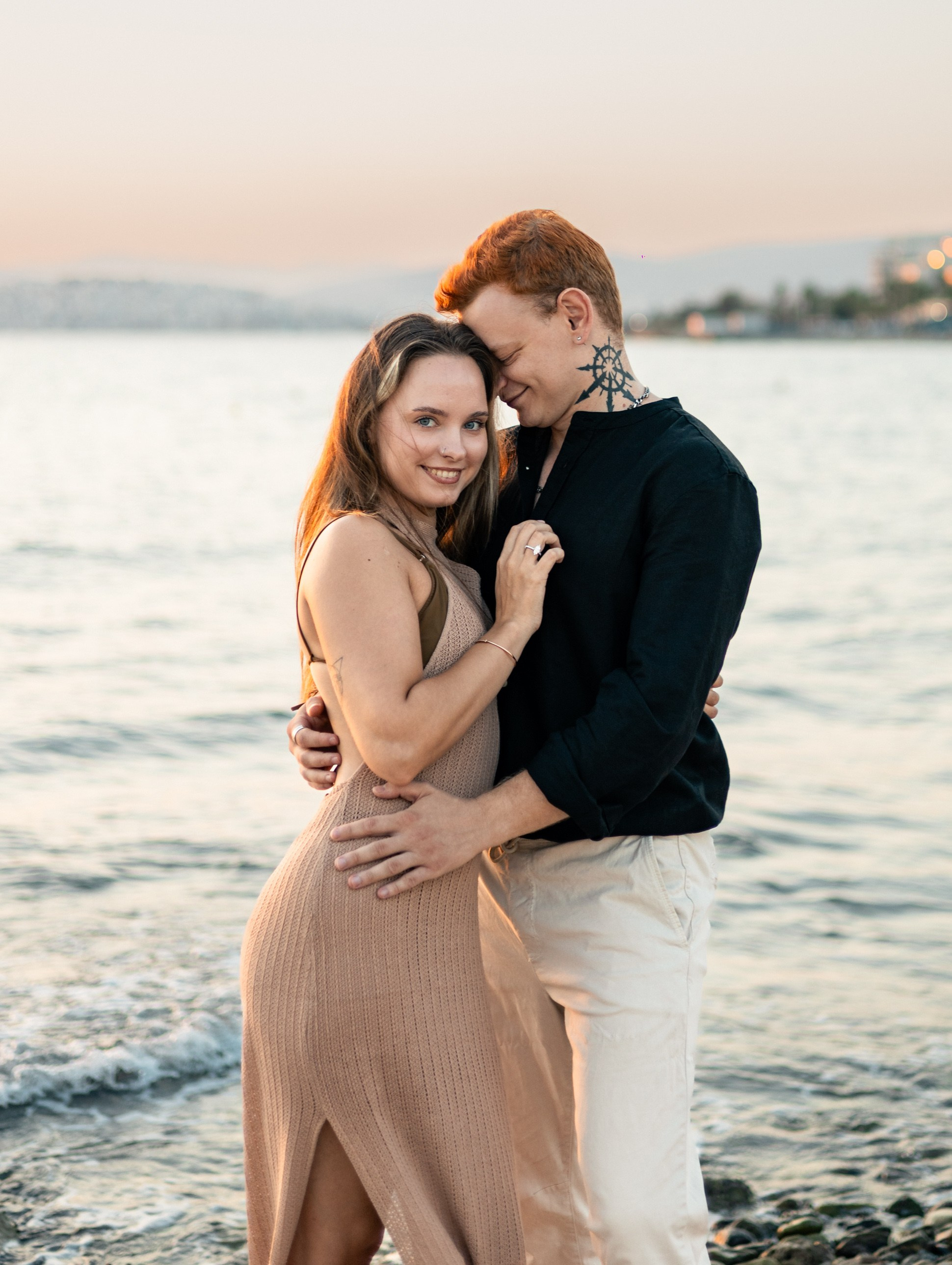Romantic couple portrait on the beach at sunset