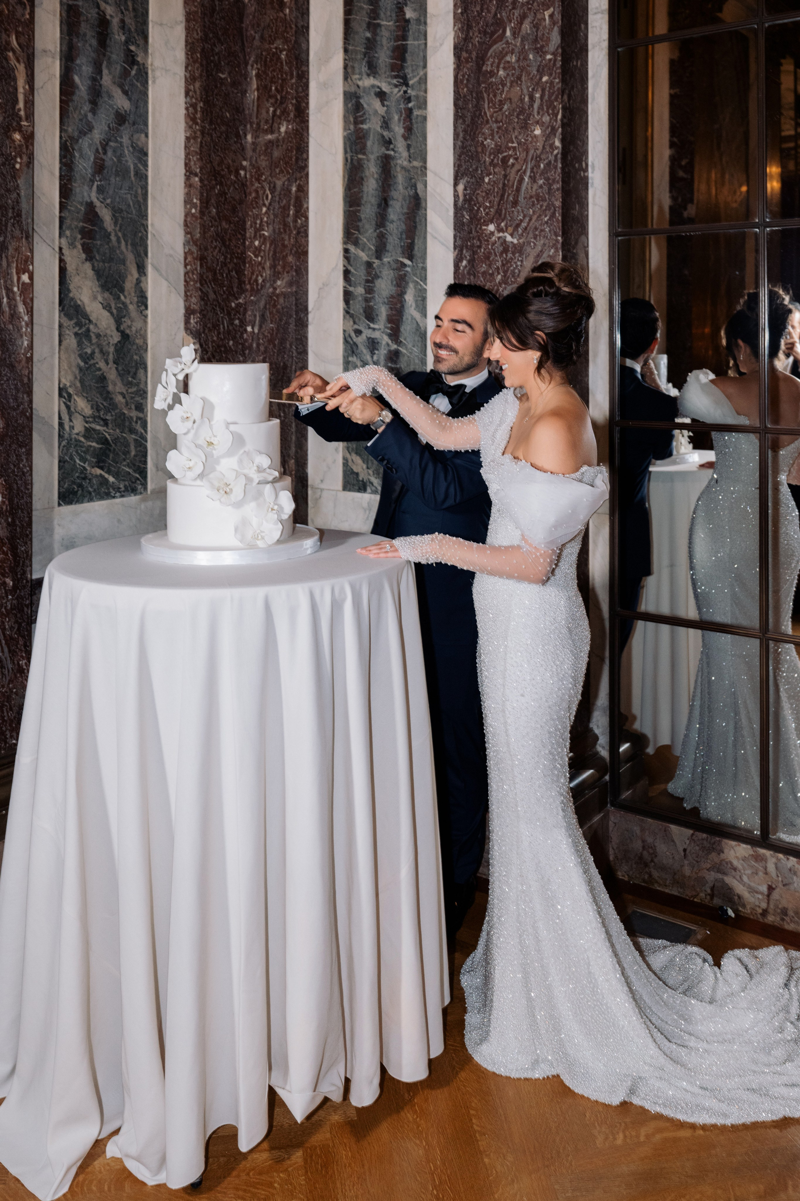 a bride and groom cutting their wedding cake