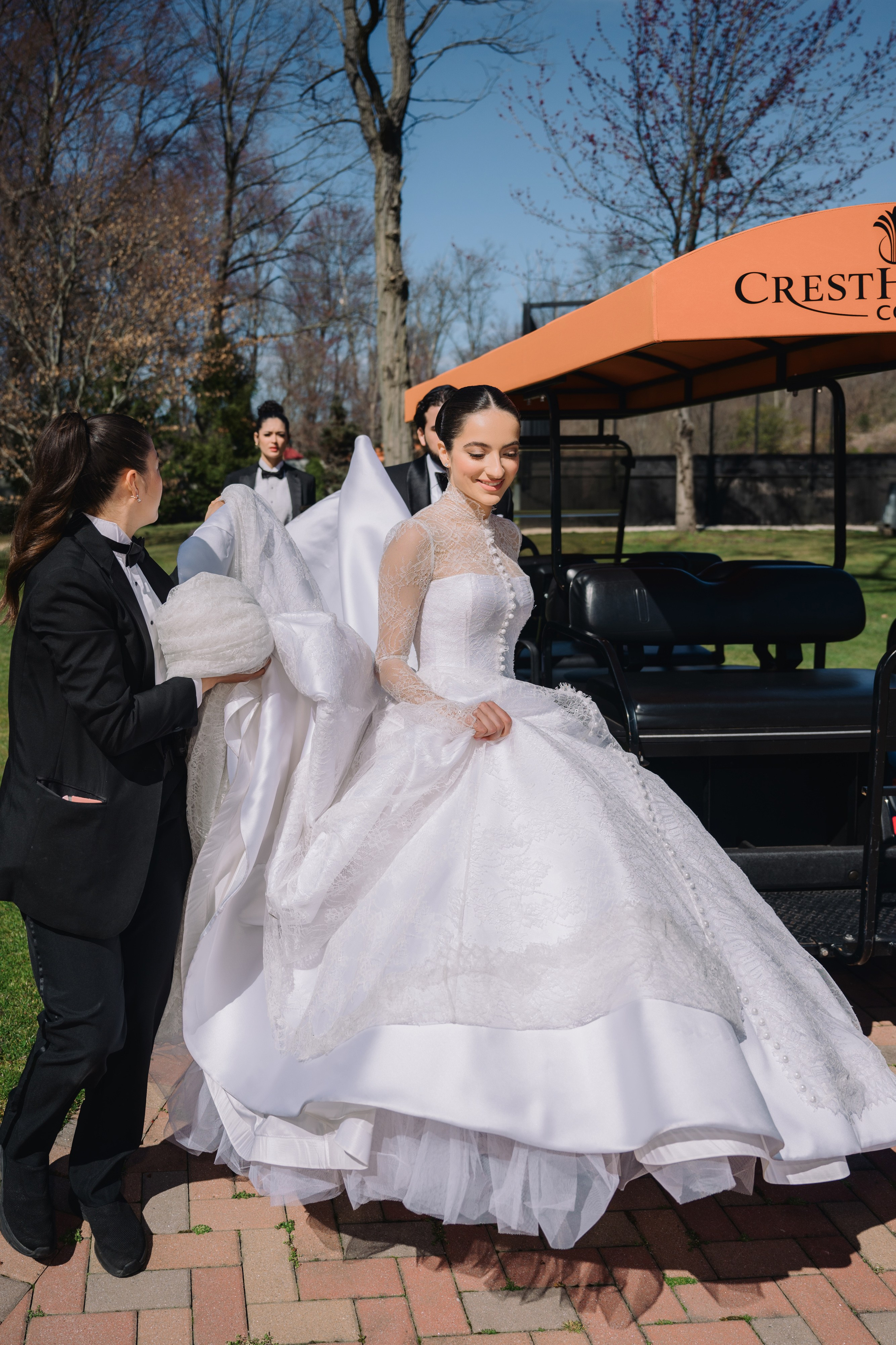 a bride is getting ready to get into her wedding dress