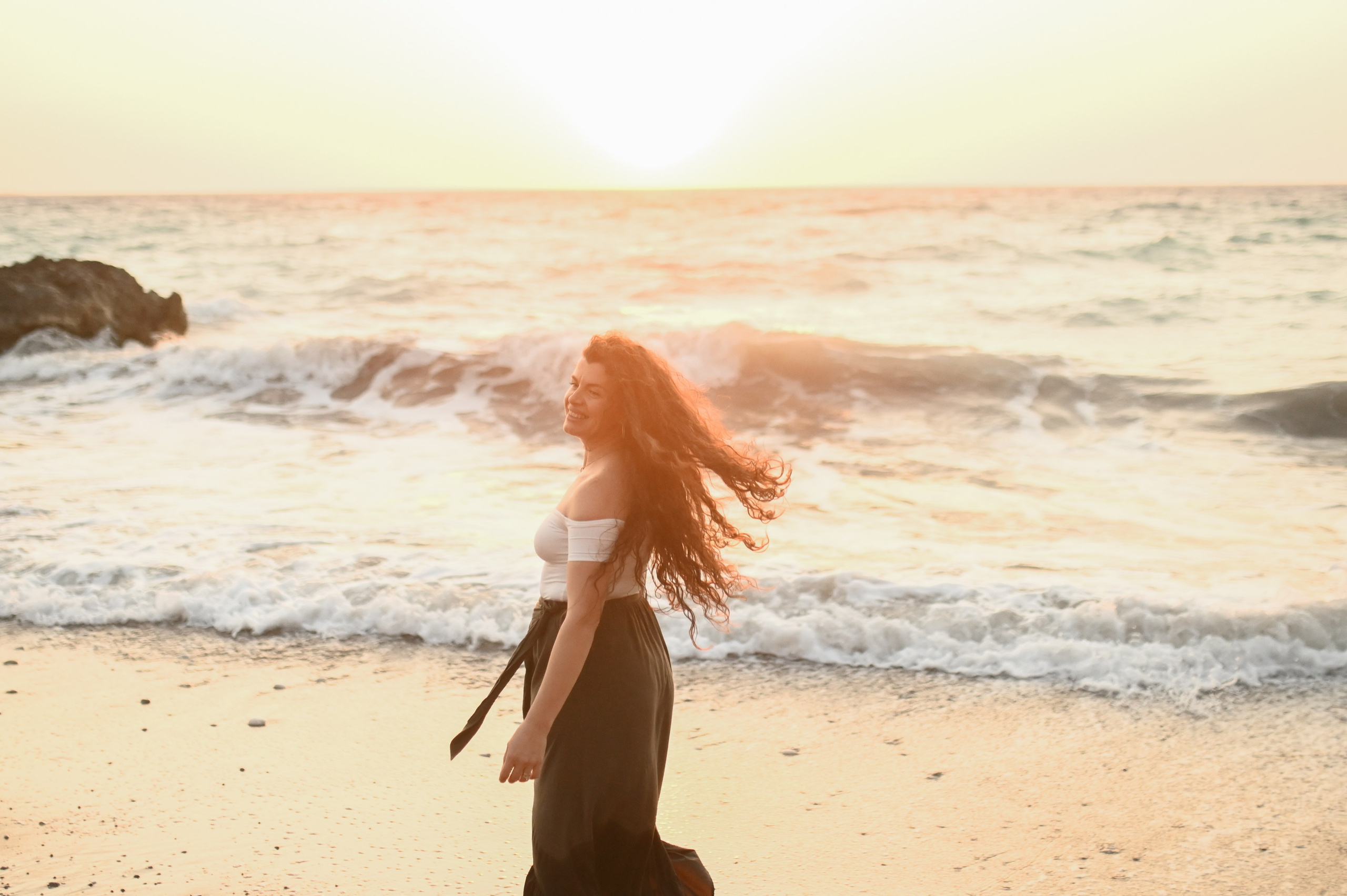 Happy family walking along a Rhodes beach at sunset. Photographer in Rhodes Island