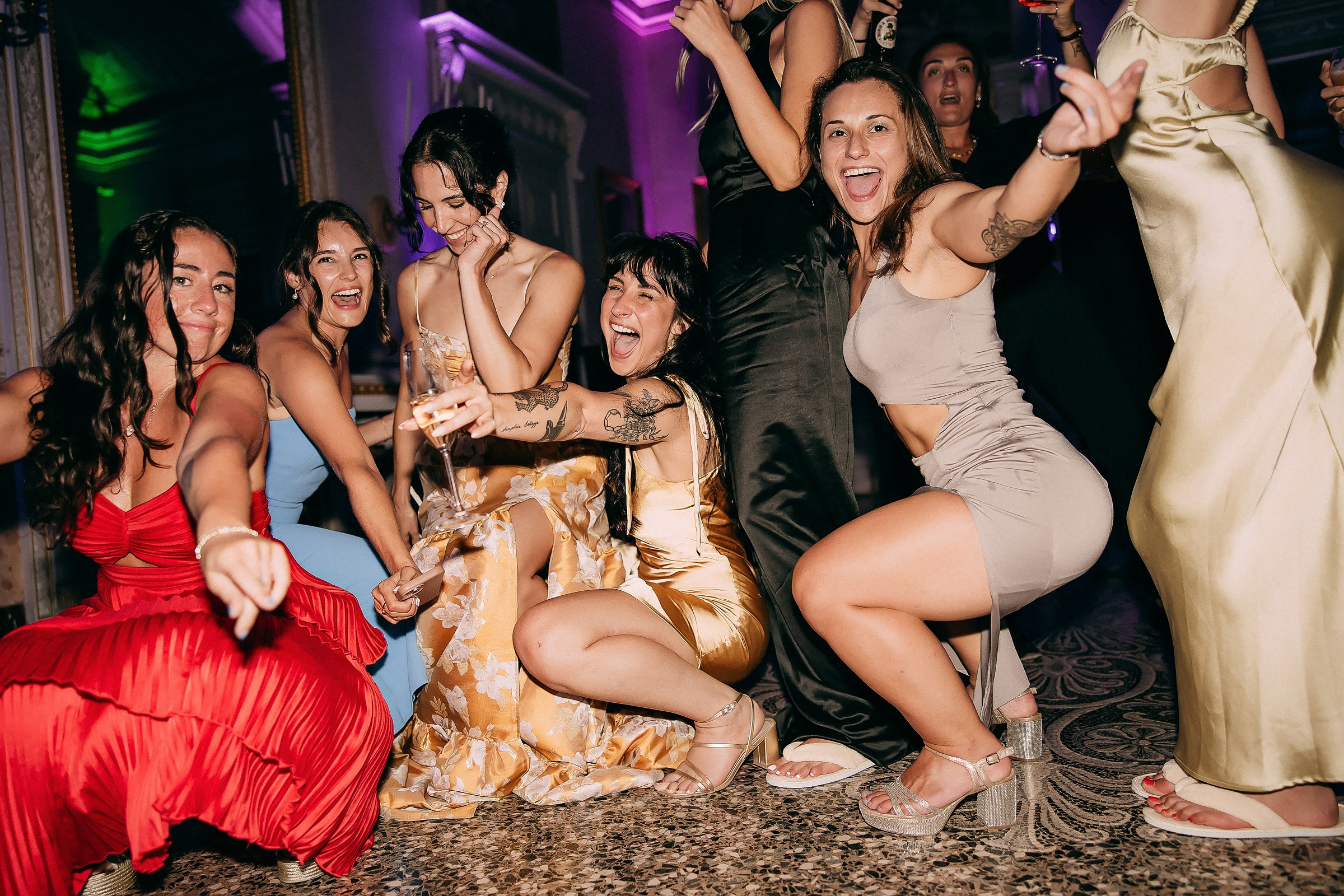 Guests laughing and dancing, fully immersed in the celebration’s vibrant energy.