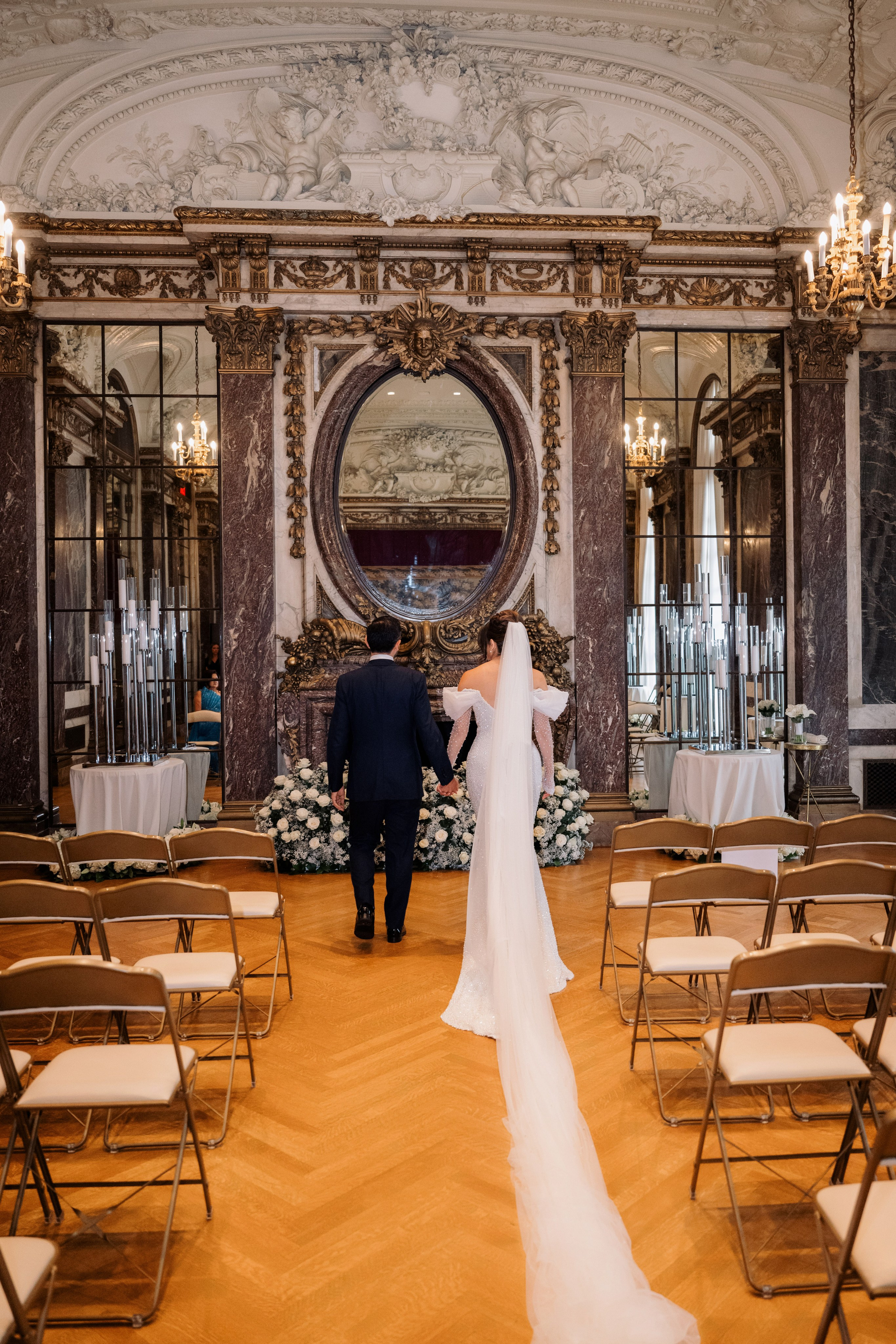 a bride and groom walking down the aisle